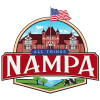 All Things Nampa logo with a historic red brick building, American flag, green fields, the lake and cows under a blue sky