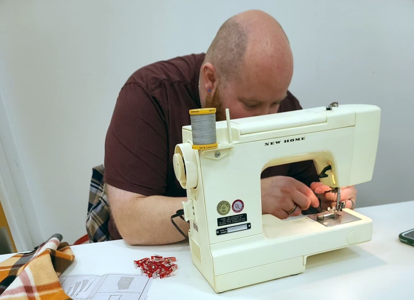 A man sewing at one of our crafternoons.