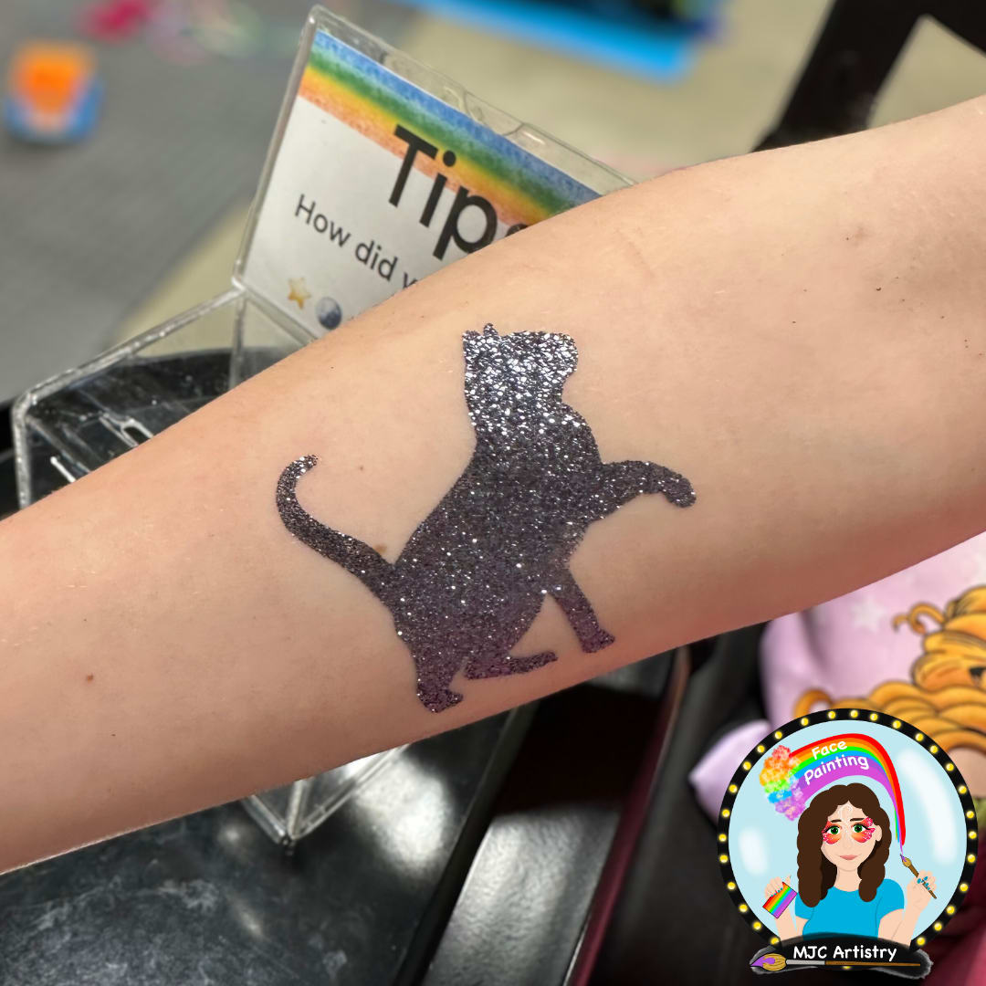 Black sparkly cat tattoo on forearm