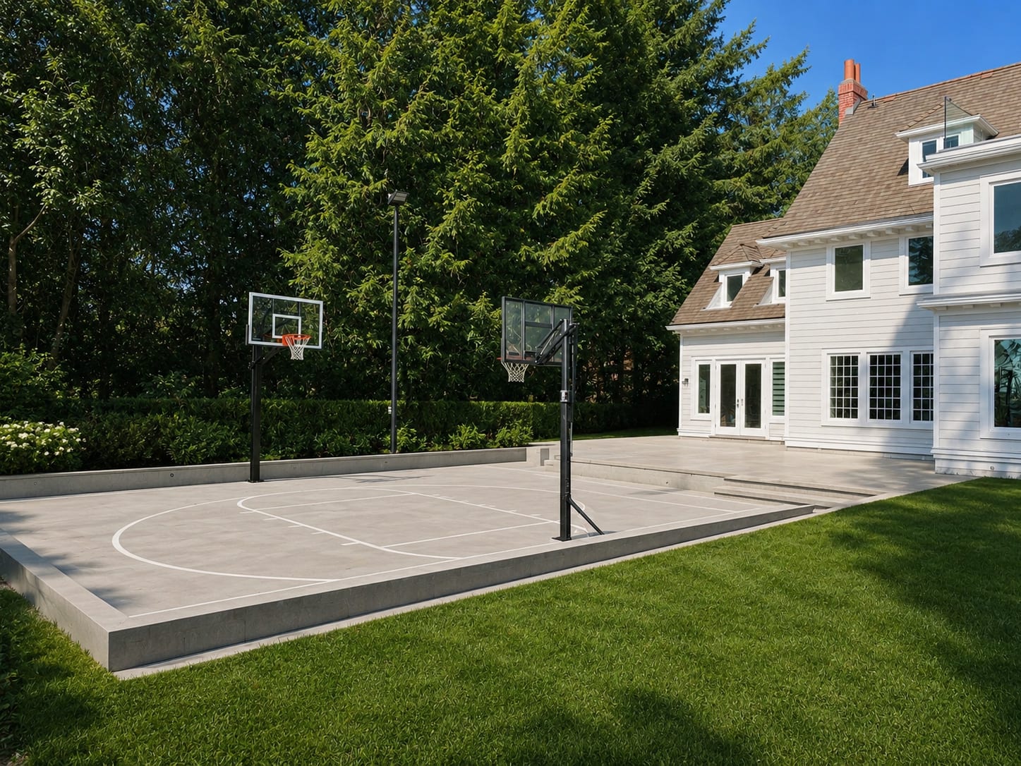 Backyard at 2040 SW Marine Drive featuring a private basketball court, landscaped lawn, mature trees and the renovated herita