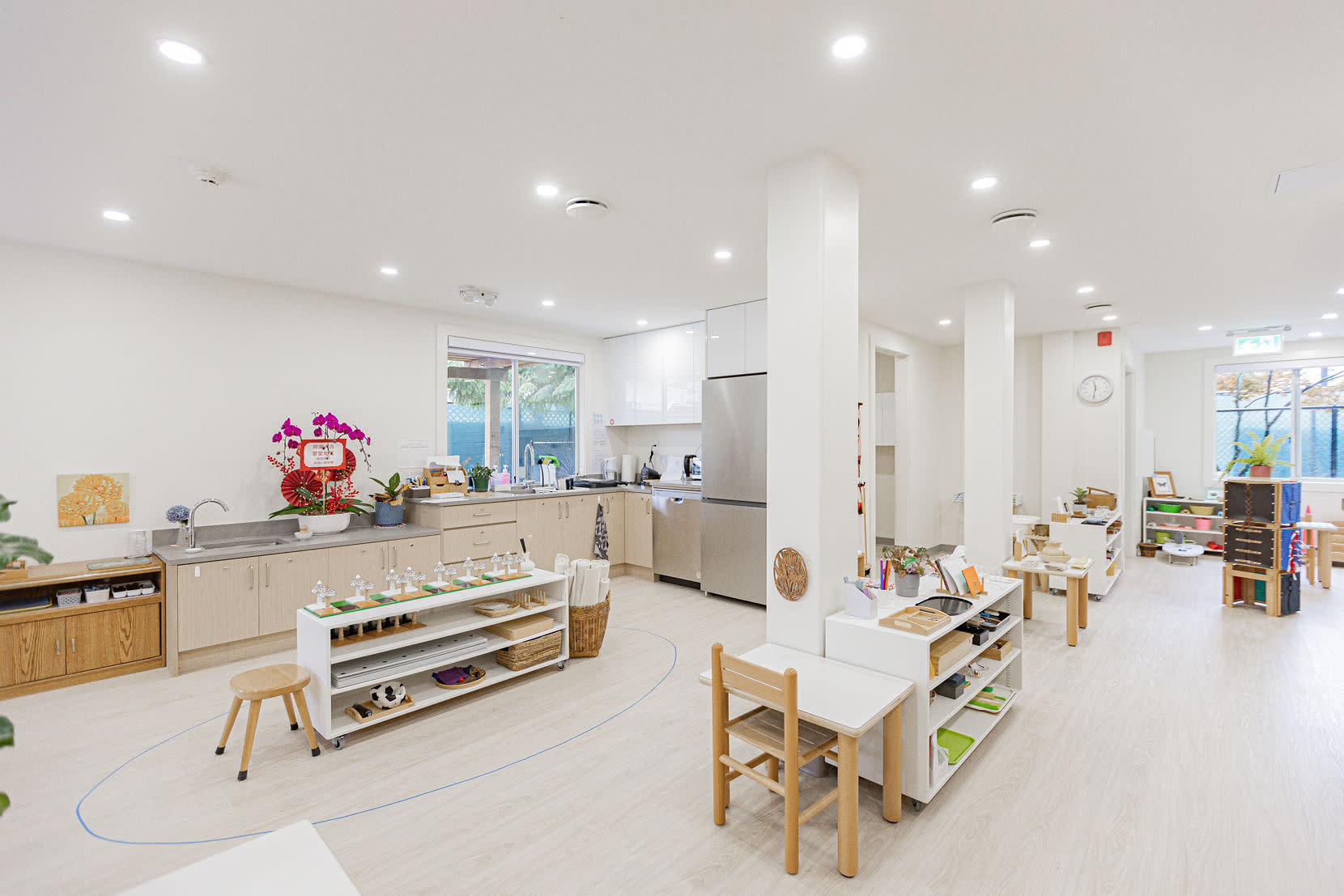 Premier Montessori Academy classroom at 6112 Sussex featuring a bright open learning space, child-sized furniture, built-in c