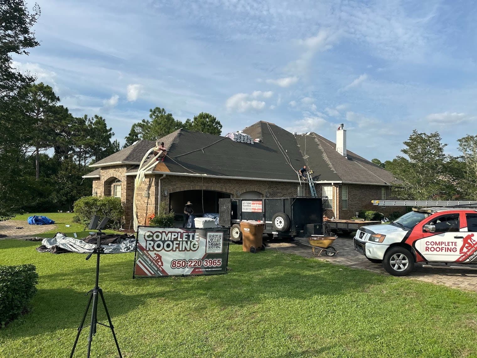 Complete Roofing crew installing a new GAF shingle roof on a large brick home in Navarre, Santa Rosa County, Florida, with th