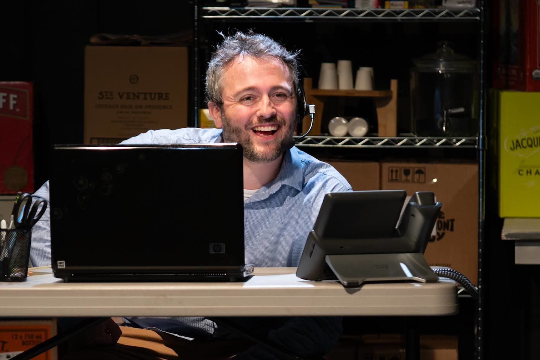 actor wearing headset smiling