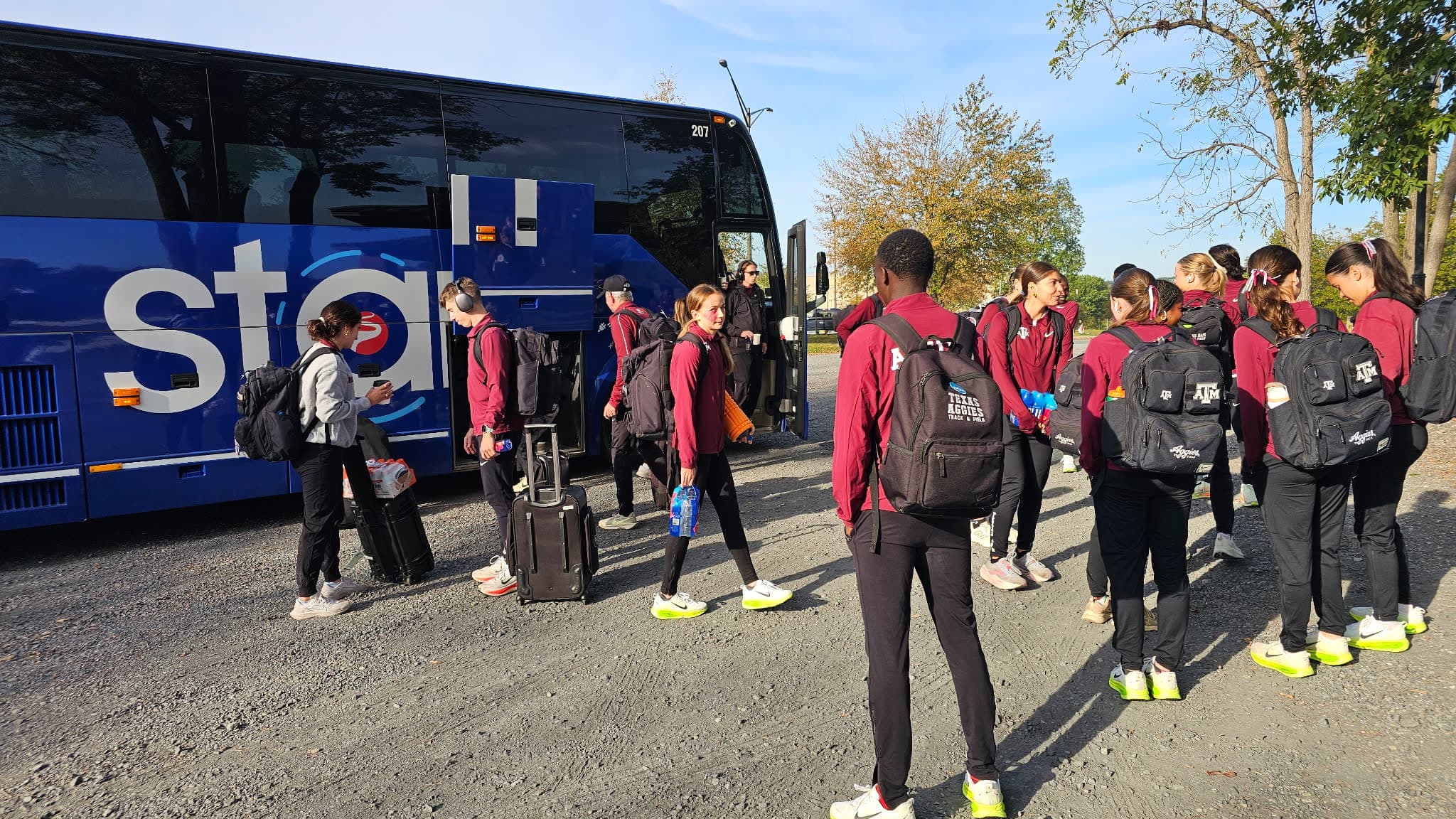 Athletes from The University of Texas Boarding Starr Bus Charter & Tours Motorcoach