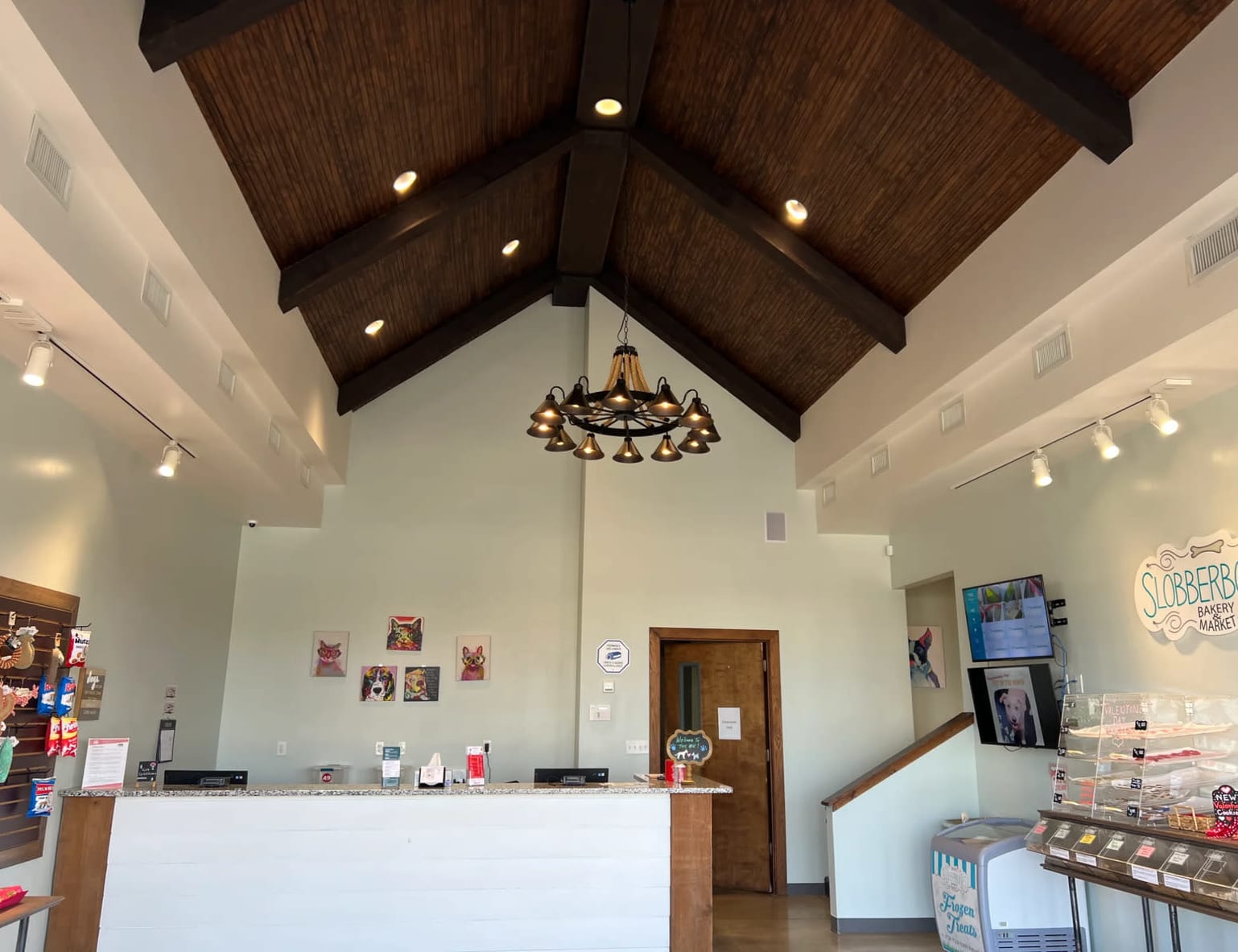 Commercial interior construction with vaulted wood beam ceiling and custom finishes completed by general contractor in Madiso