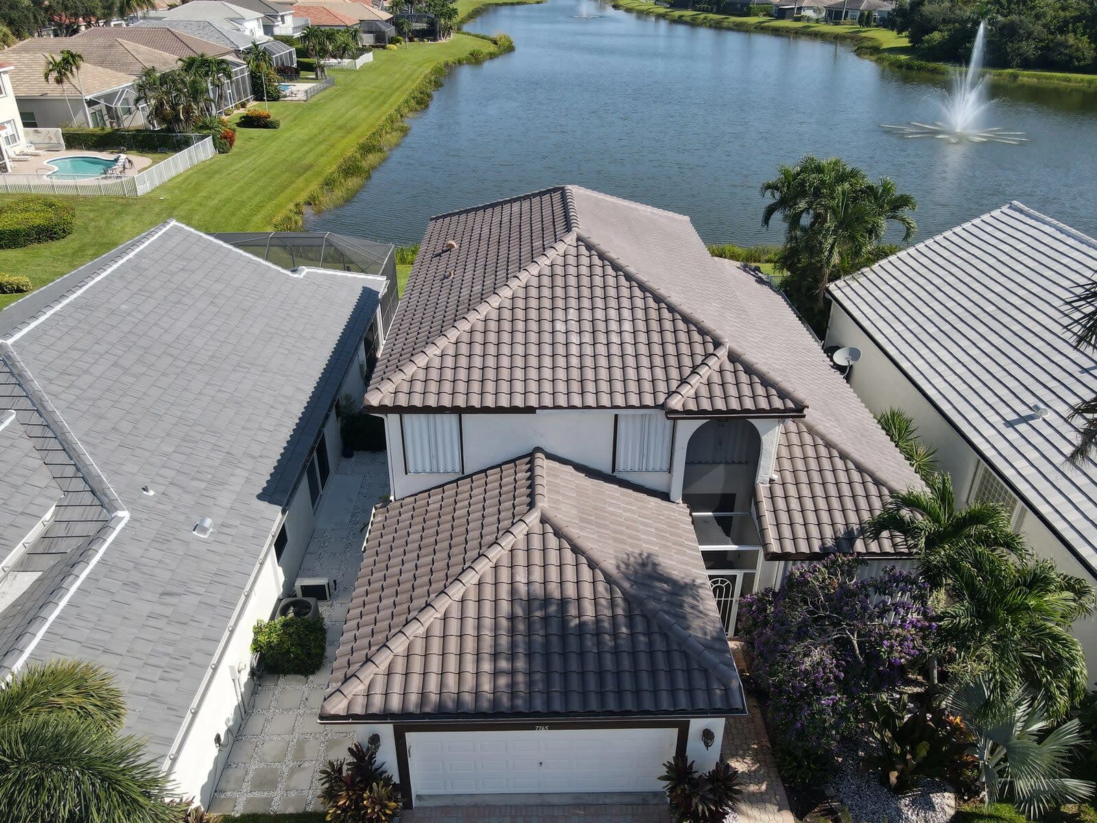 Finished brown tile roof on a two-story lakeside home in Delray Beach