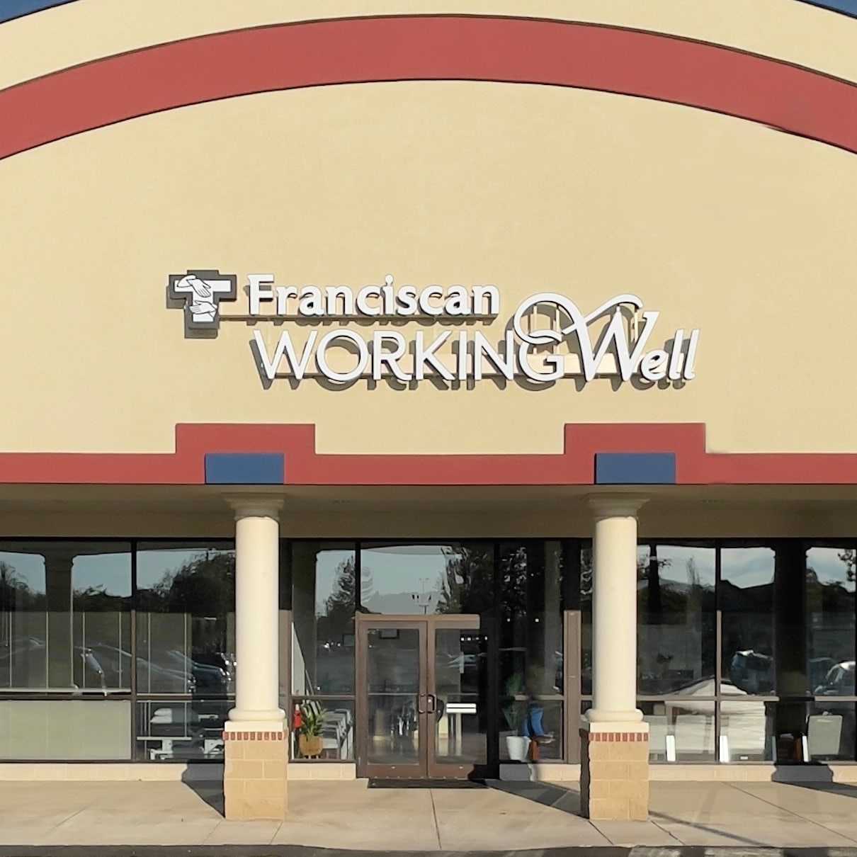 Exterior of the Franciscan WorkingWell clinic in West Lafayette, Indiana, featuring the building entrance and signage for emp