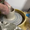 Potter throwing on the wheel