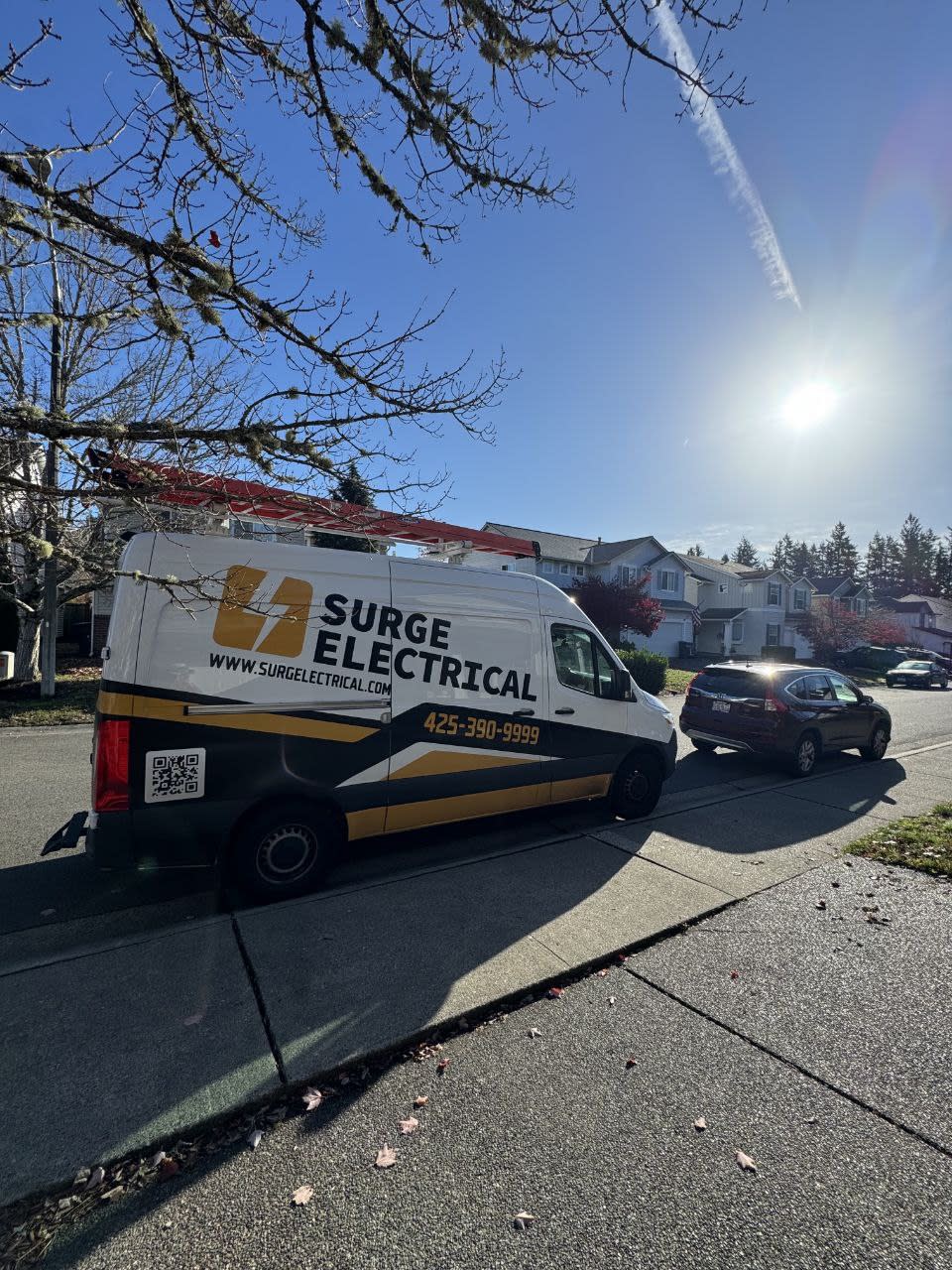 Surge Electrical service van parked in a Seattle neighborhood during a residential electrical job.