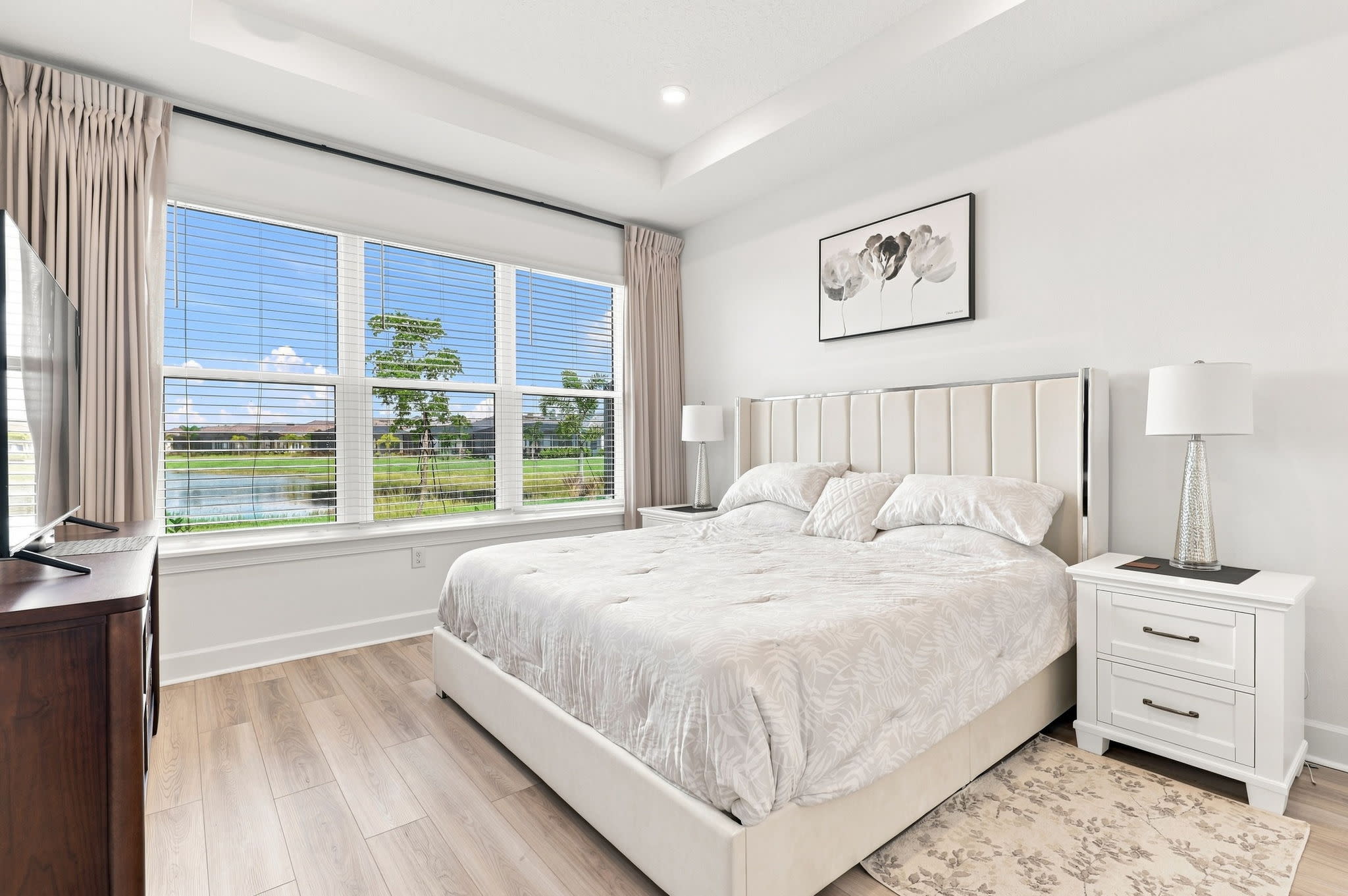 Professional real estate photography of a bright primary bedroom in Sarasota, Florida by Bird Real Estate Media