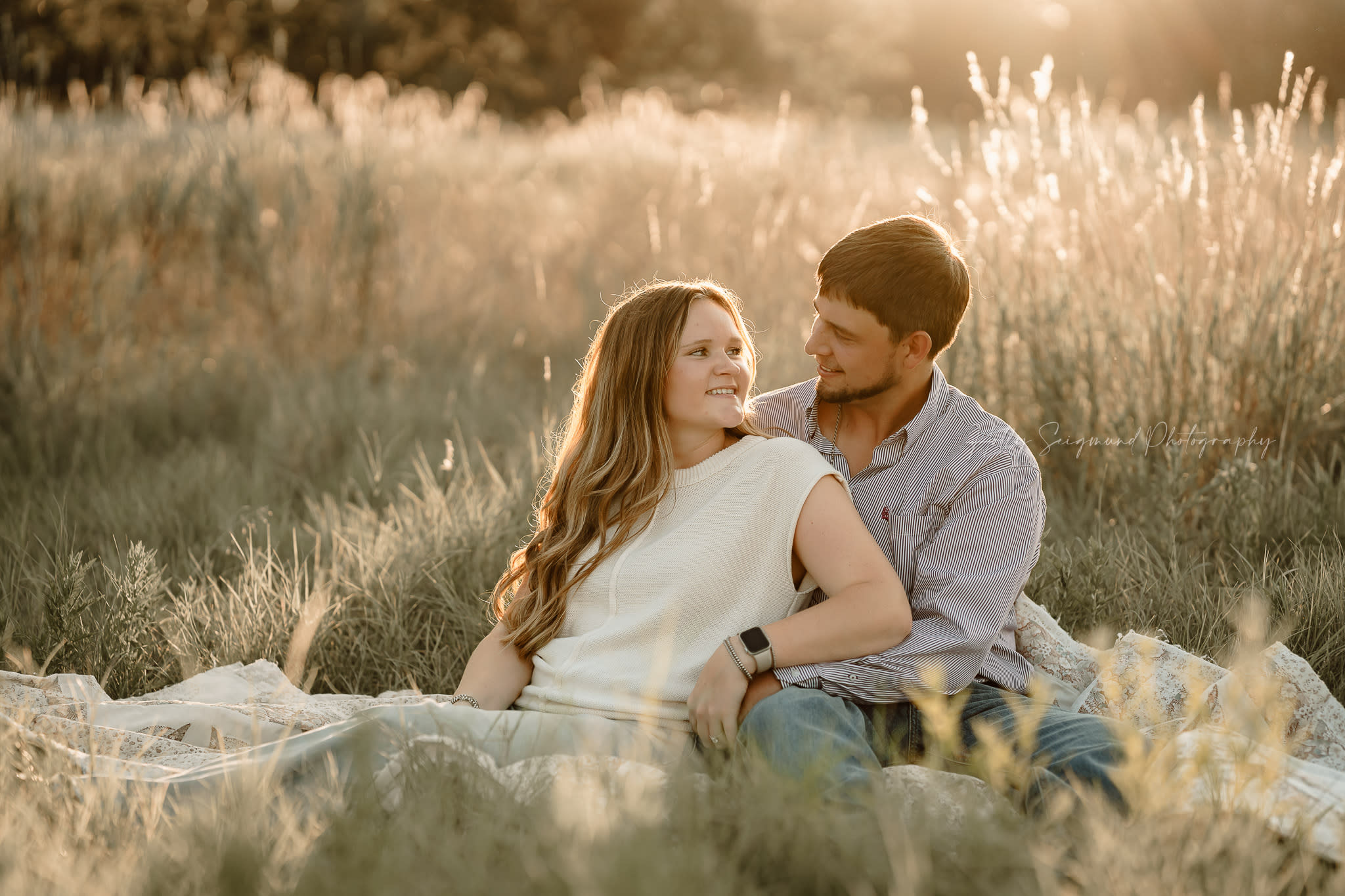 Couples Engagement Photography in field of glowing weeds in the country