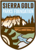 Sierra Gold Parks Foundation logo- badge shaped, mining wheel, the covered bridge, Yuba River and bluff of 3 state parks