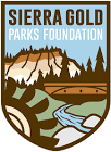 Sierra Gold Parks Foundation logo- badge shaped, mining wheel, the covered bridge, Yuba River and bluff of 3 state parks