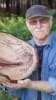 Mike Snegg Bowls- showing Mike Snegg holding handcrafted and carved wooden bowl fine art