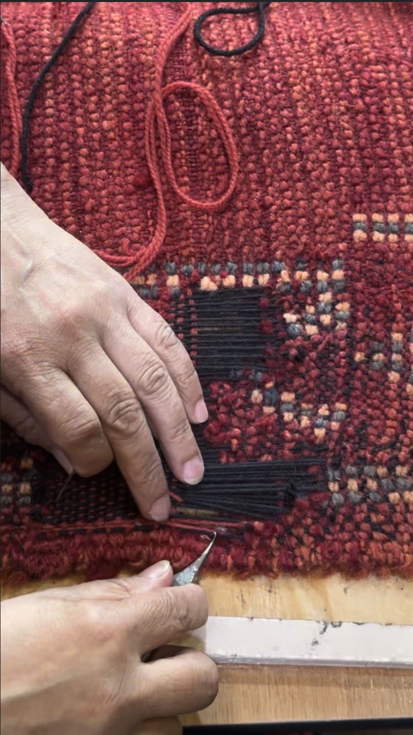 Reweaving the rug foundation with needles