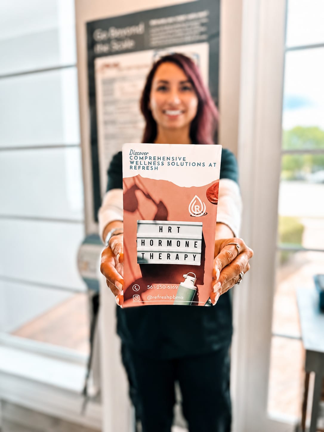 Refresh - Aesthetics & Wellness provider holding an HRT hormone replacement therapy brochure in Florida