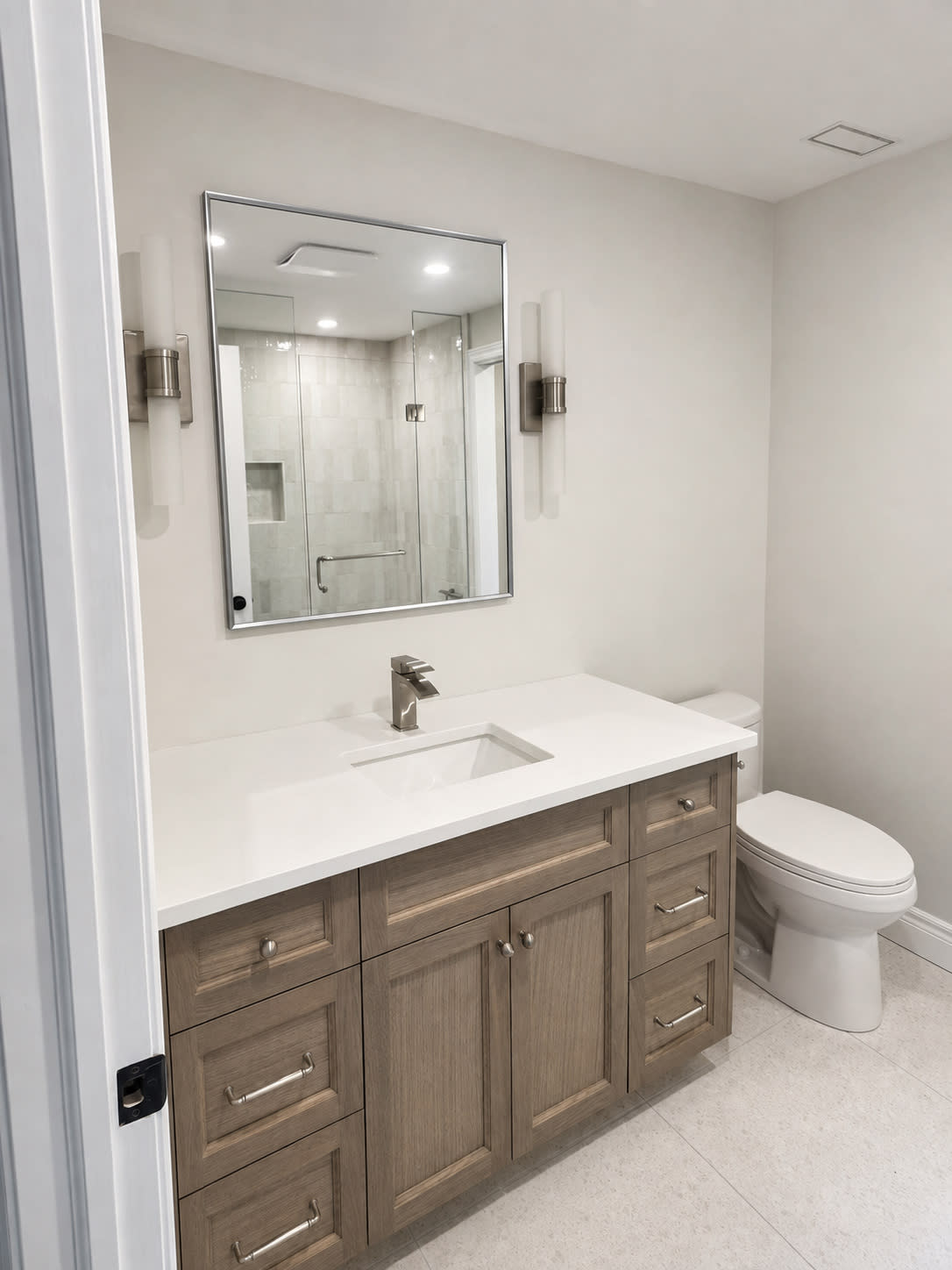 Appledale Crescent renovation in Waterloo featuring a modern bathroom with a glass-enclosed shower, custom vanity and premium