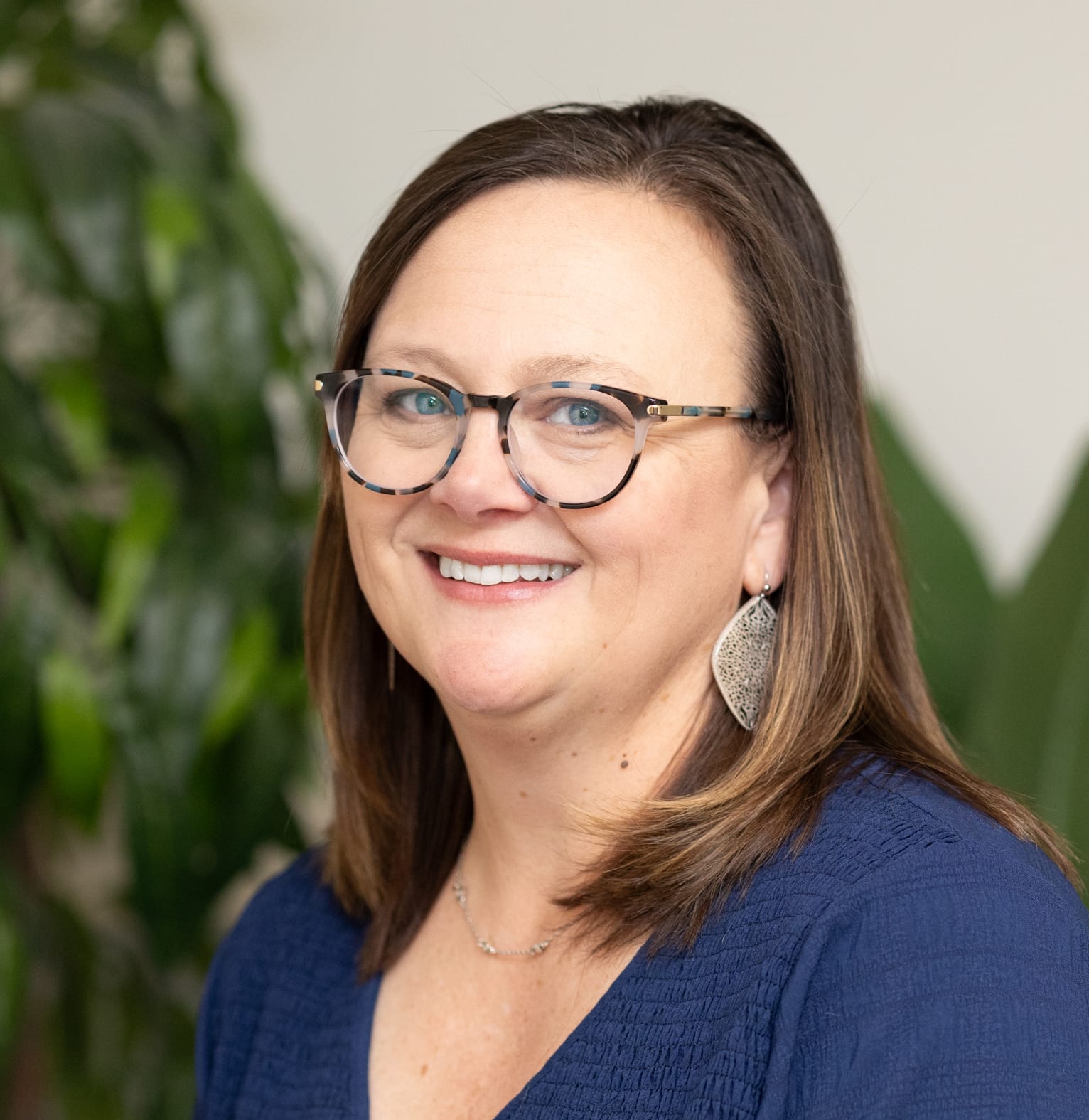 picture of woman wearing glasses in a blue dress