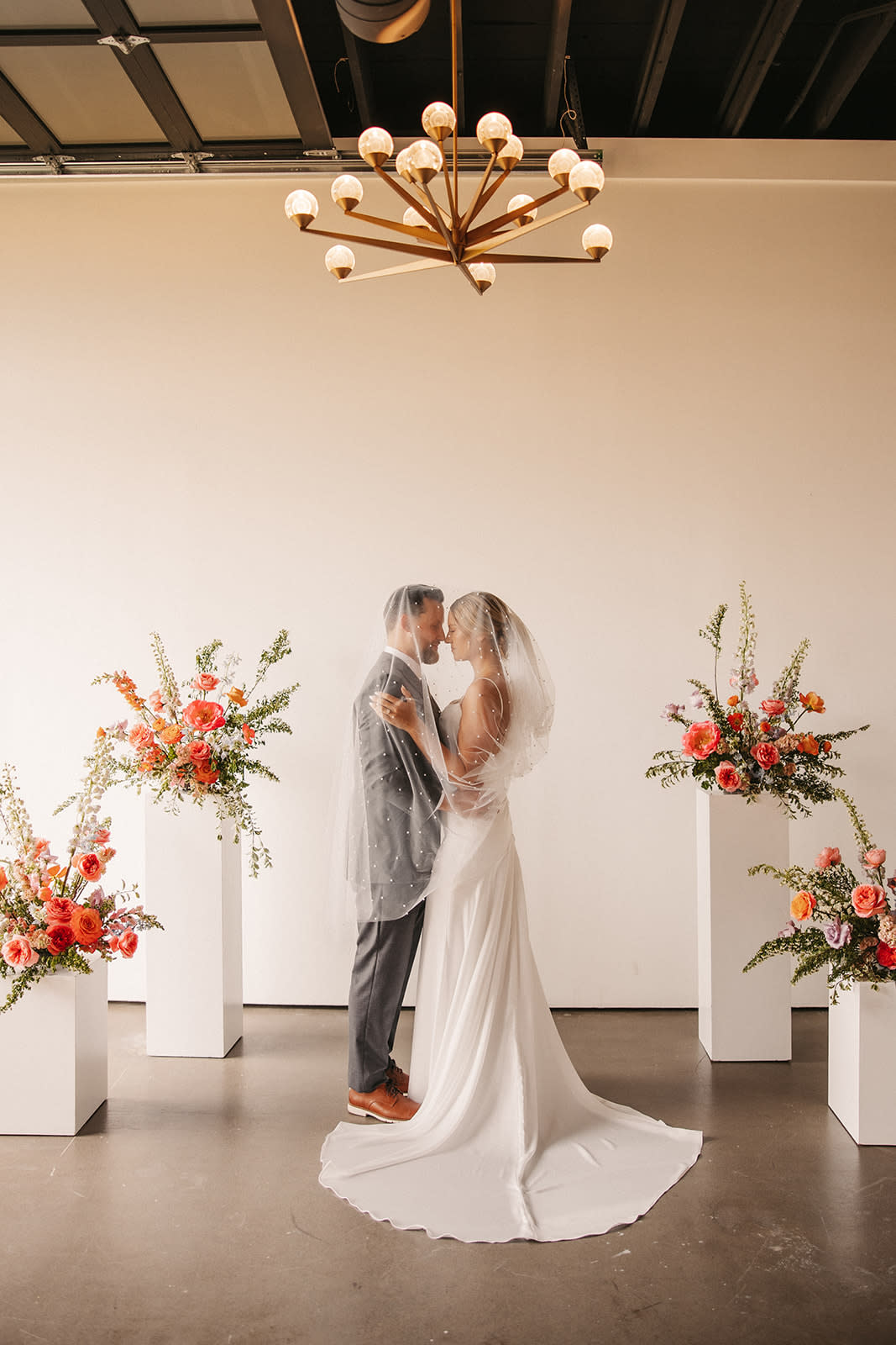 Bride and groom posing inside The Main Hall at Bestow Events.