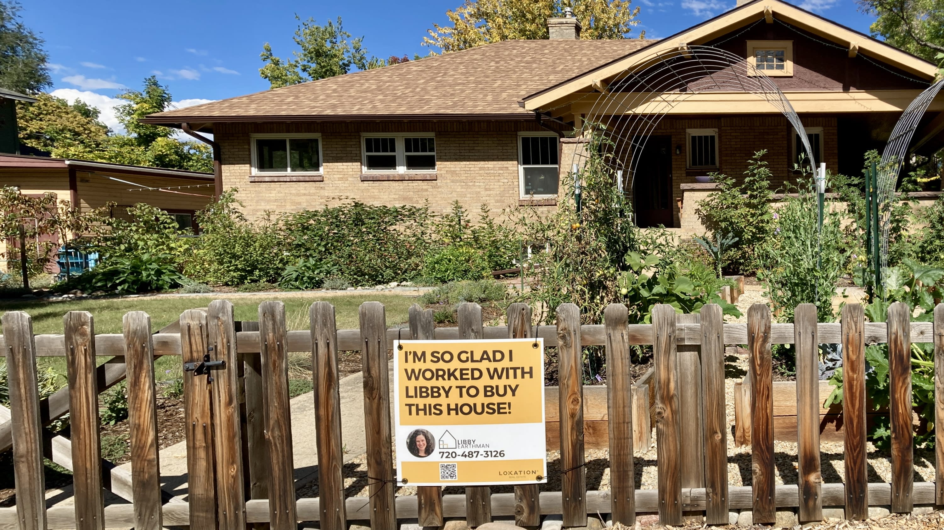 A yard sign in front of a home in Longmont's Historic Eastside reads "I'm so glad I worked with Libby to buy this house!"