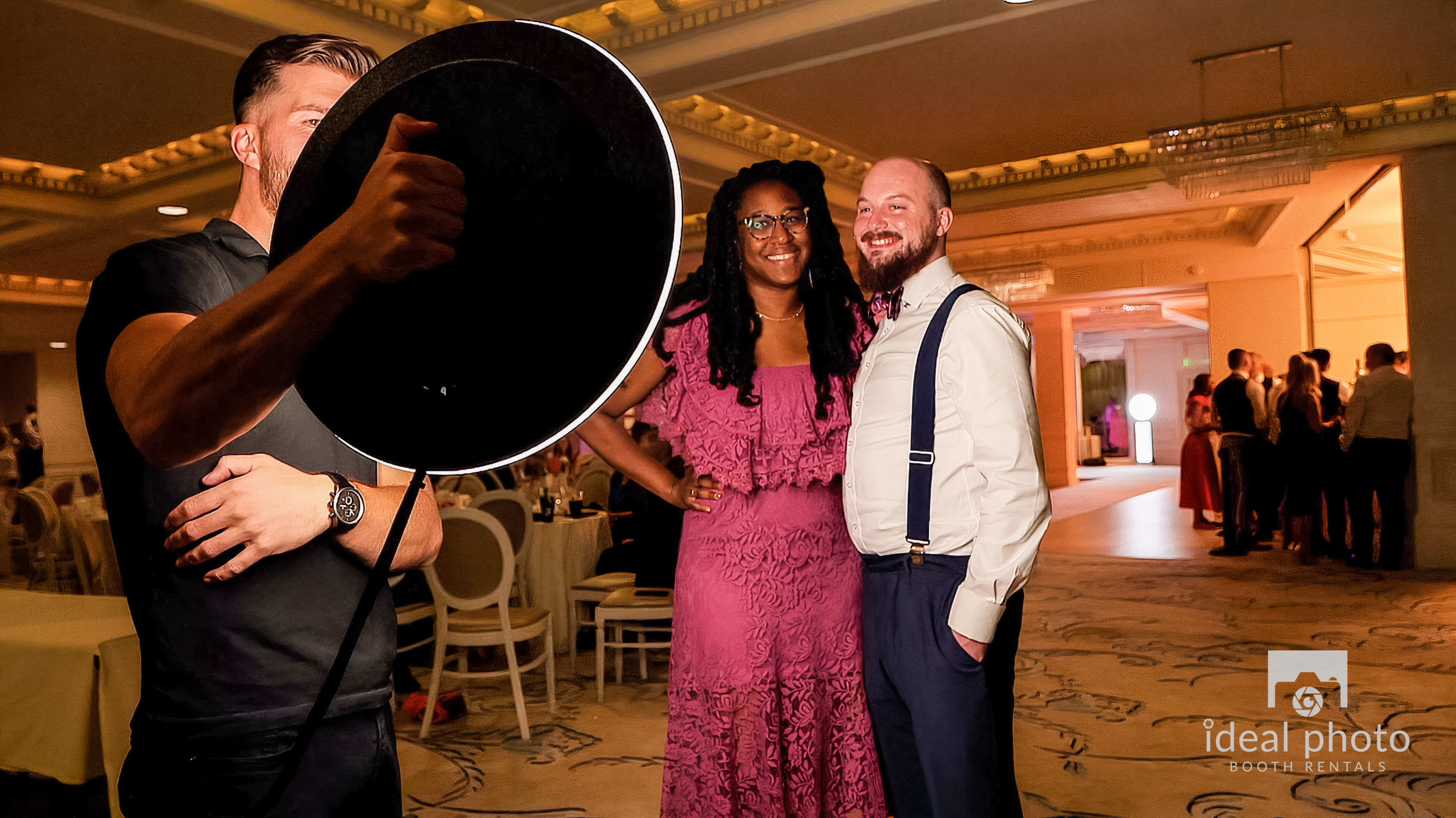 Event guests taking photos with a roaming photo booth at a corporate event in Louisville, Kentucky.