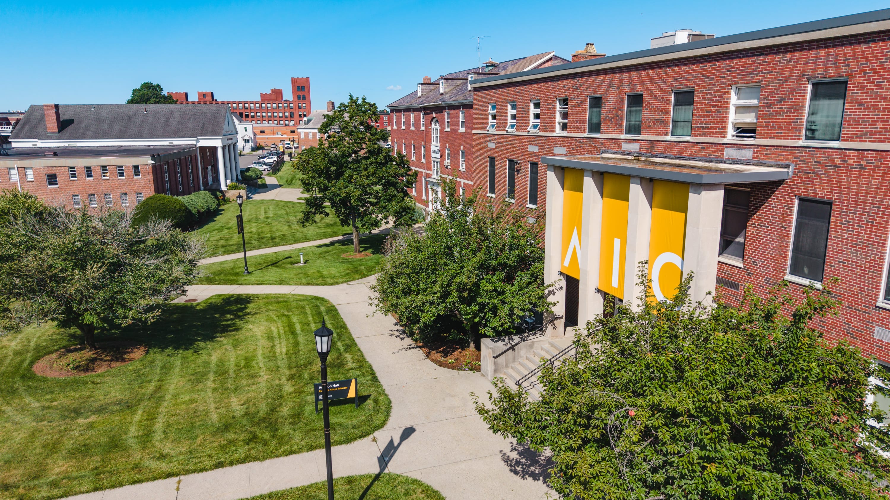 Iconic AIC banners hang outside Amaron Hall at American International College