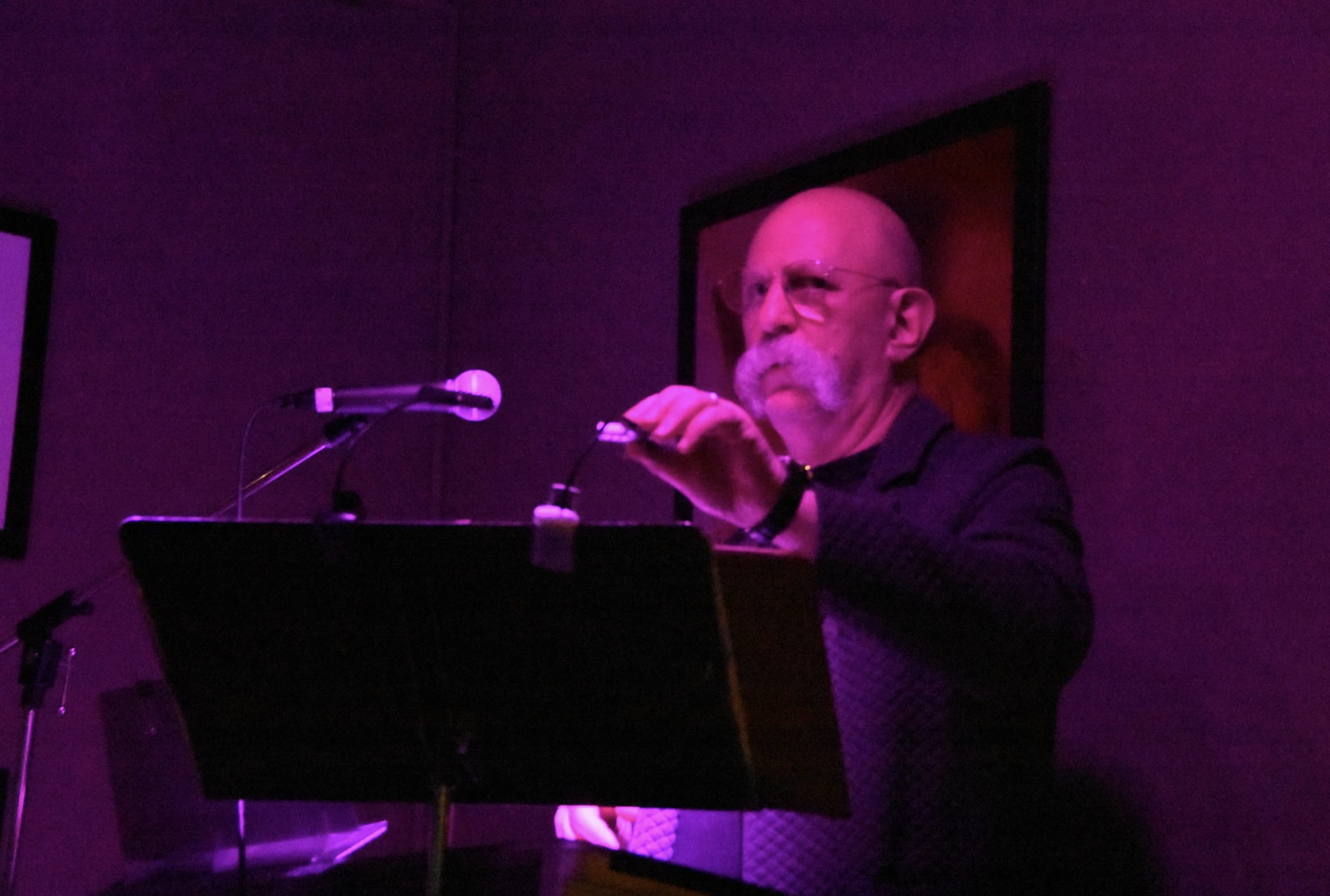 In this image, Raoul, Johnny's accompanist is playing the piano.  There is purple lghting in this scene to show the gloomines