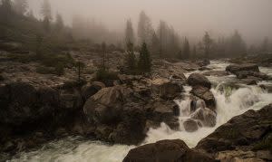 California Heritage of Indigenous Research Project and Uba Seo Gallery photo of waterfall on rocks in misty wilderness