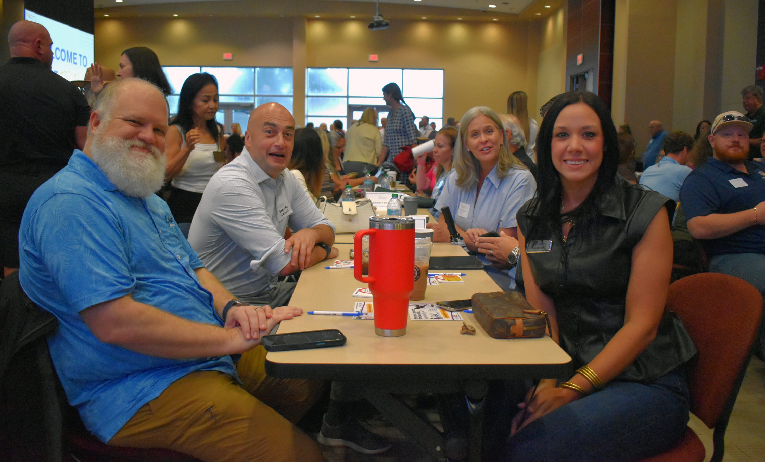 Bay County Chamber members and guests gather around a table during October First Friday.
