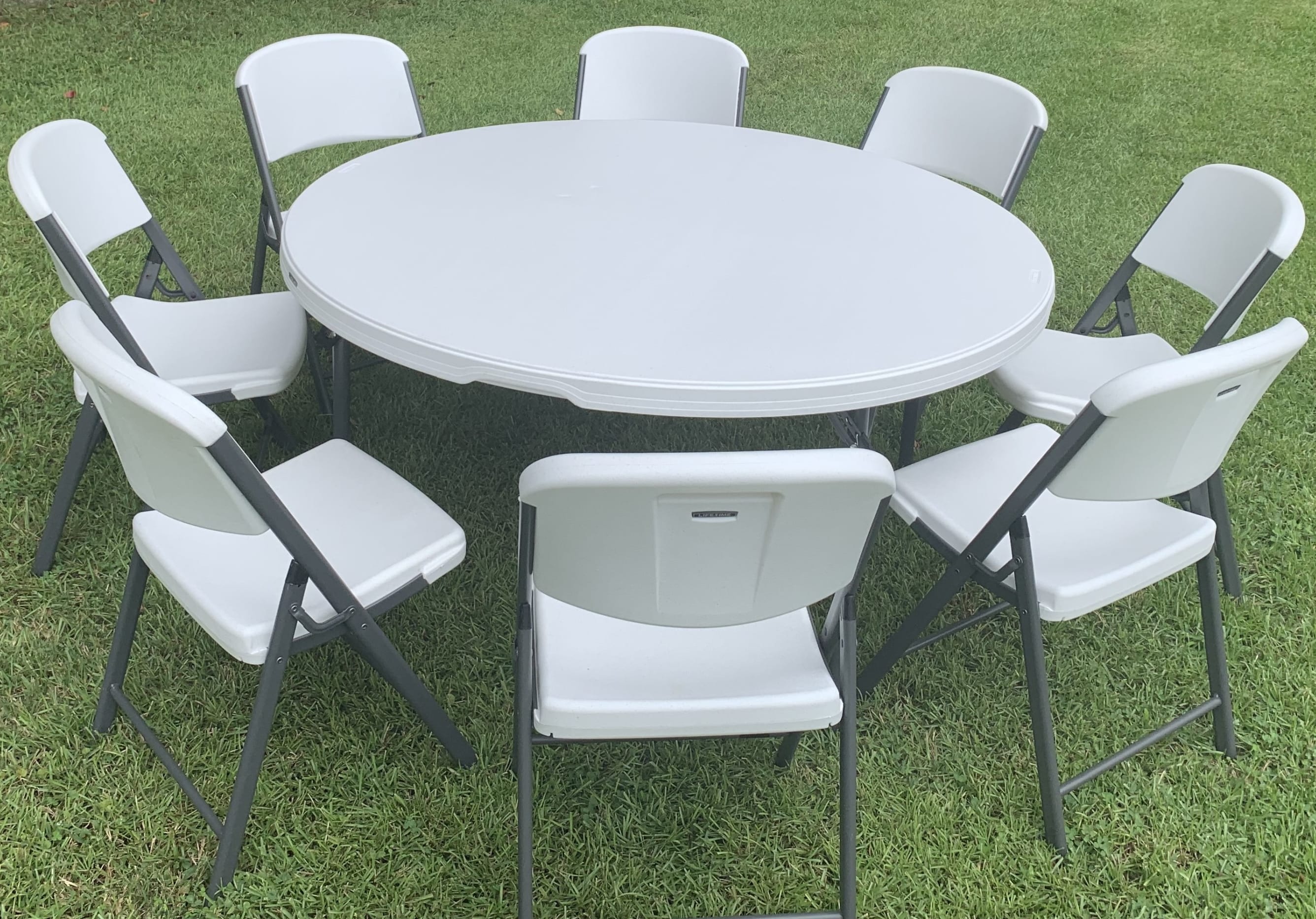 5' round table and white plastic chairs