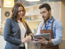 Two Business Owners Looking at iPad