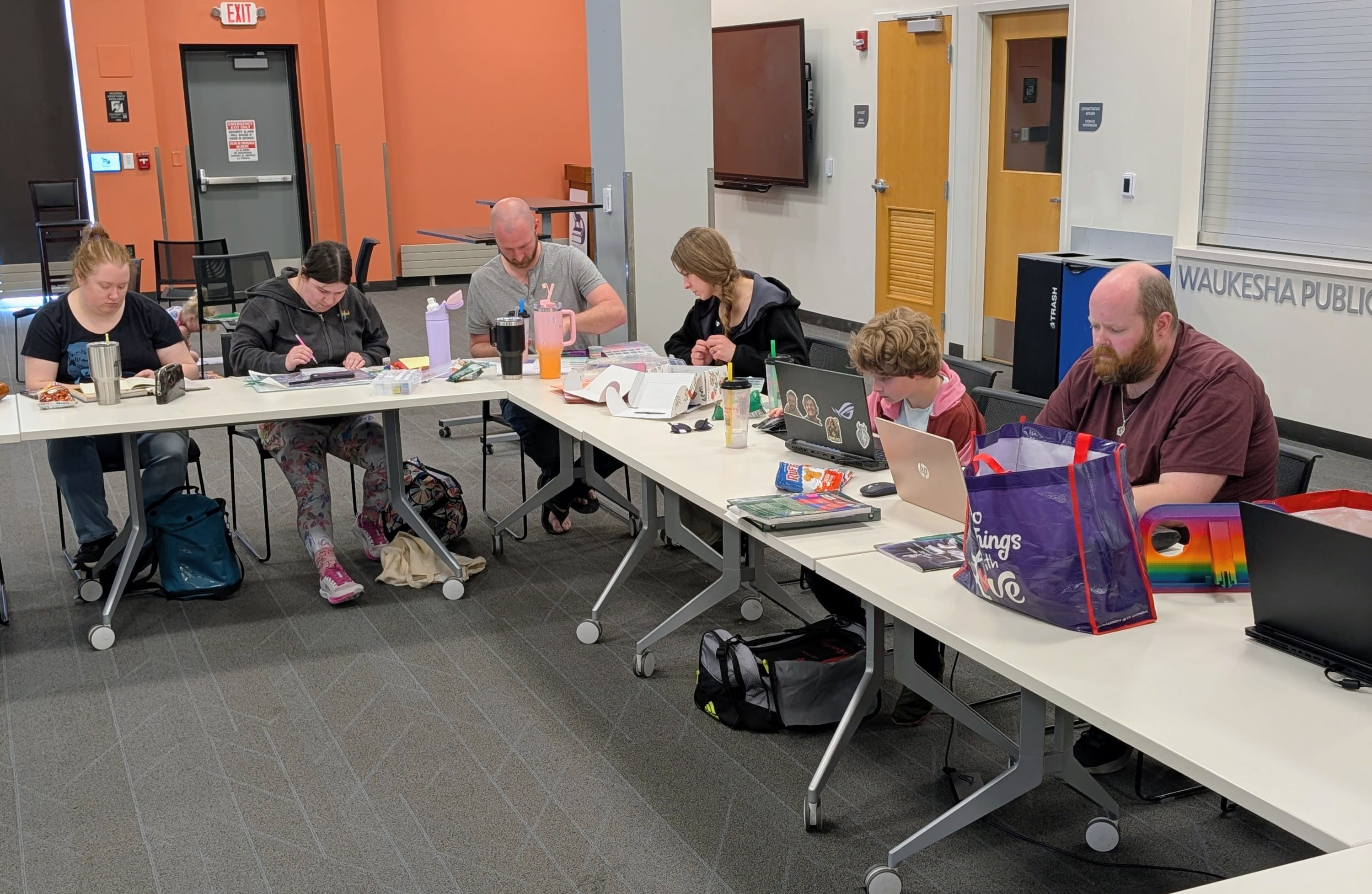 A group of people working on a variety of crafts.