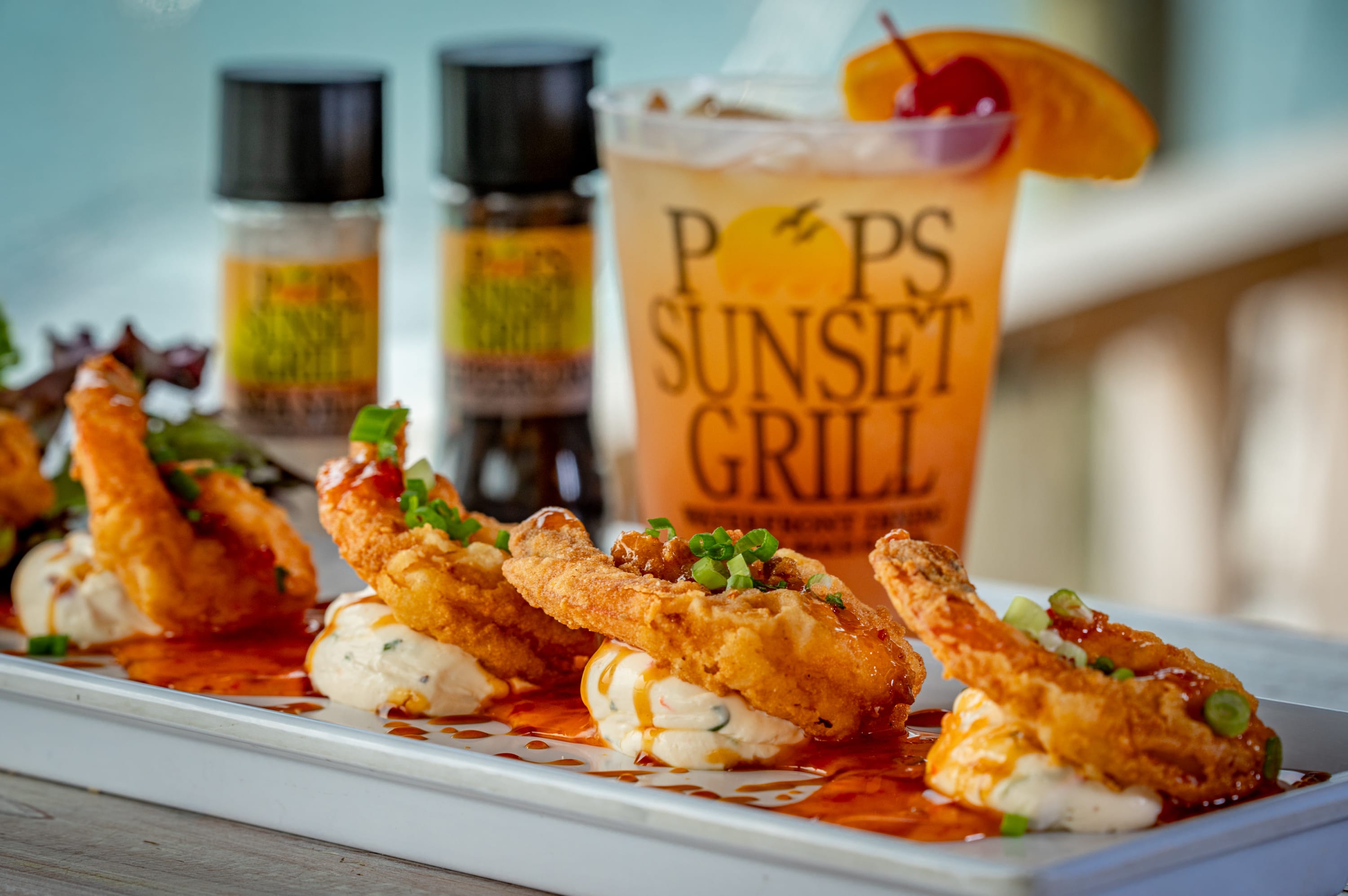 Fried shrimp with herbed cream cheese and a tropical drink