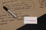 Writing on a piece of paper with a Sharpie and a You Matter card