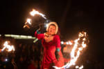 woman in santa gear fire dancing at Victorian Christmas in Nevada City