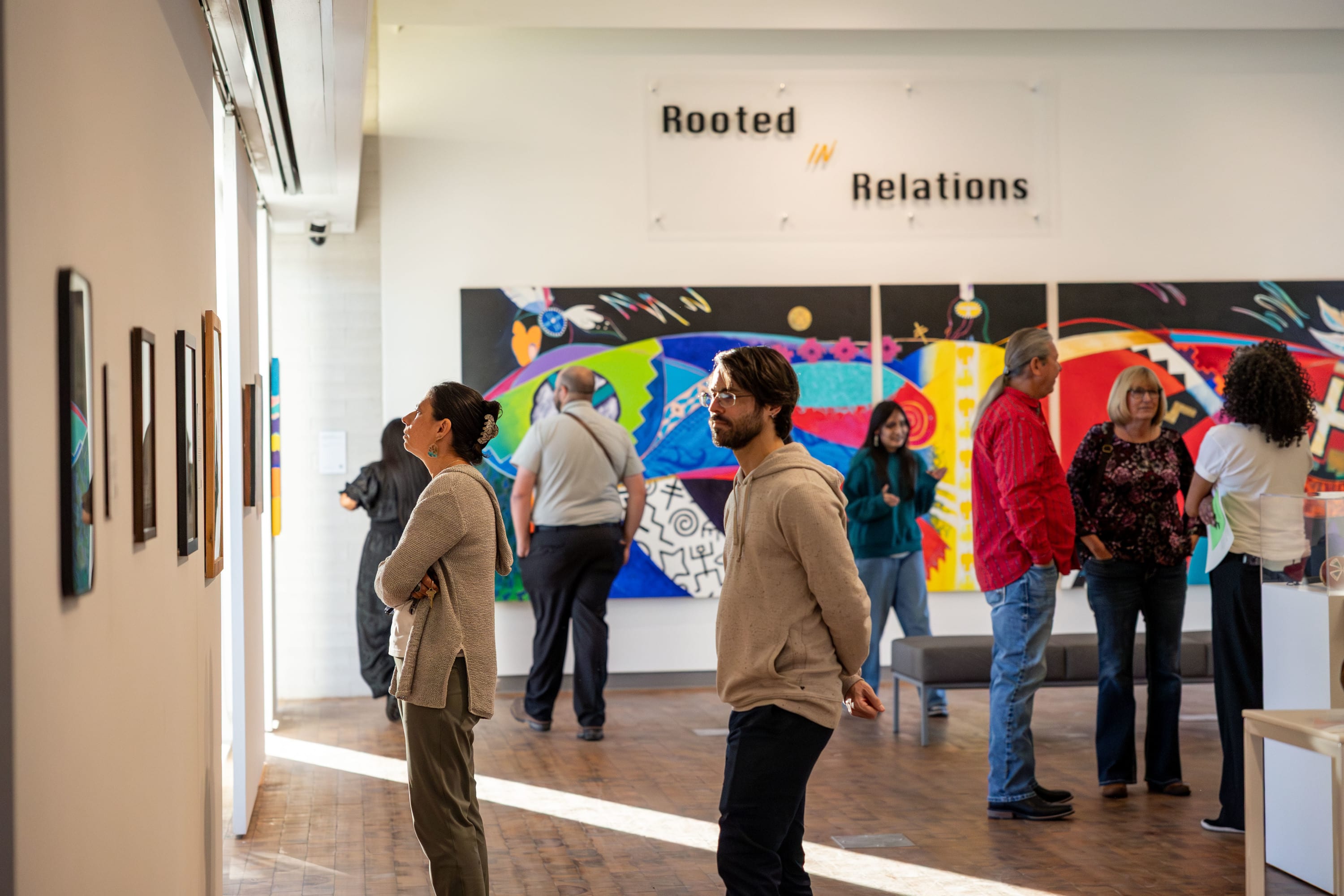 People standing and viewing art in the MCC Art Gallery
