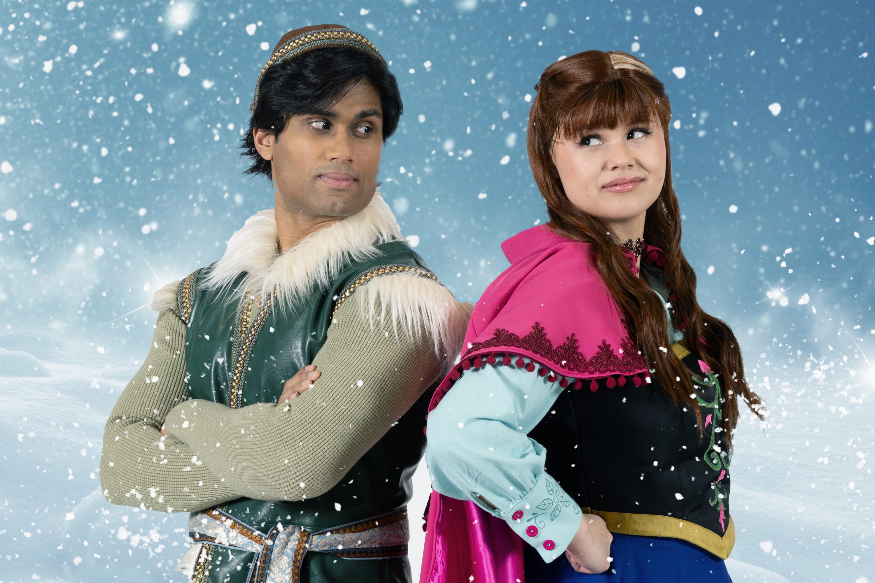 Kristoff (Sadat Hossain) stands with his arms crossed rolling his eyes at Anna (Lauren Berling) who poses with her hands on h