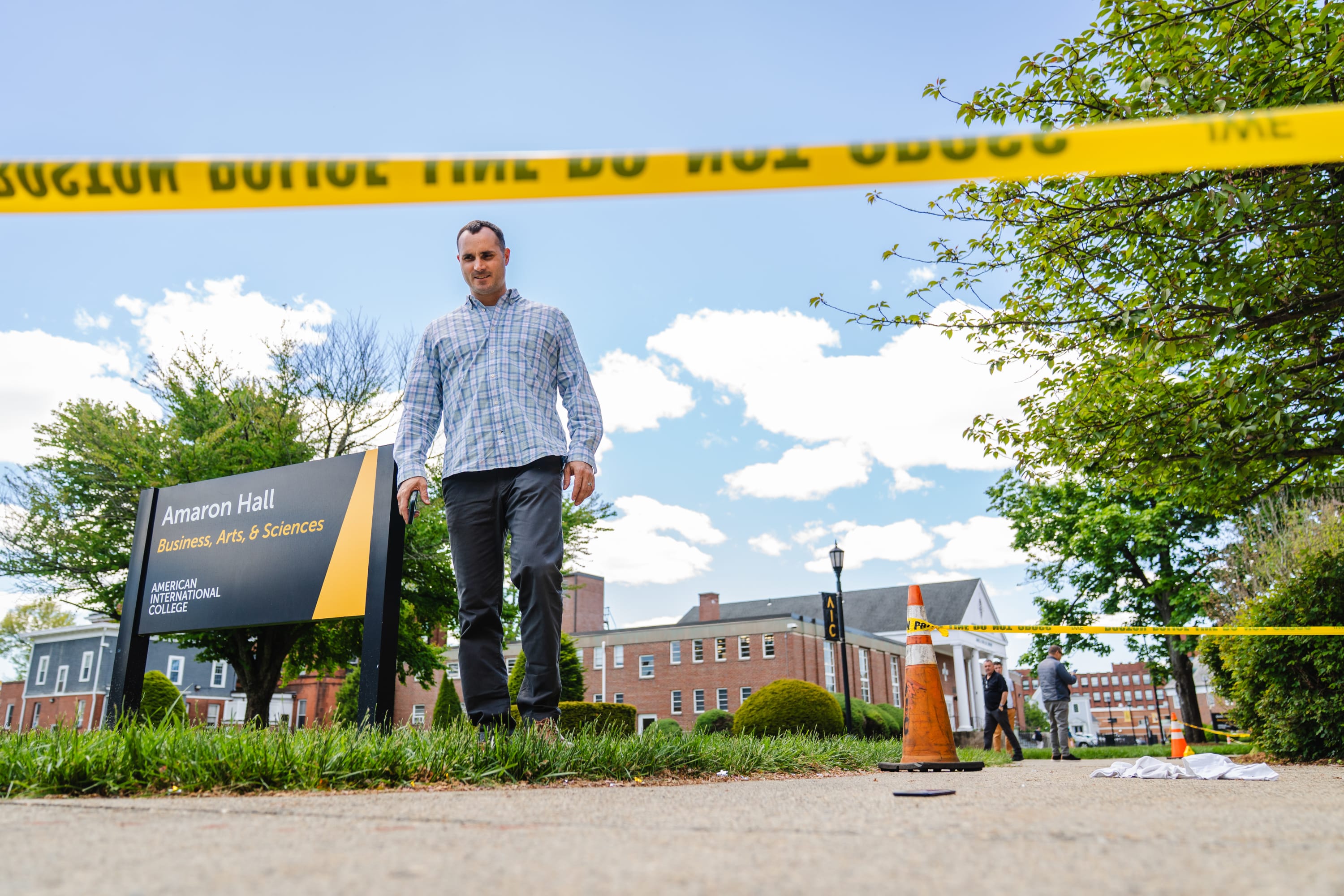 A Springfield Police officer participates in a training exercise in front of Amaron Hall at American International College