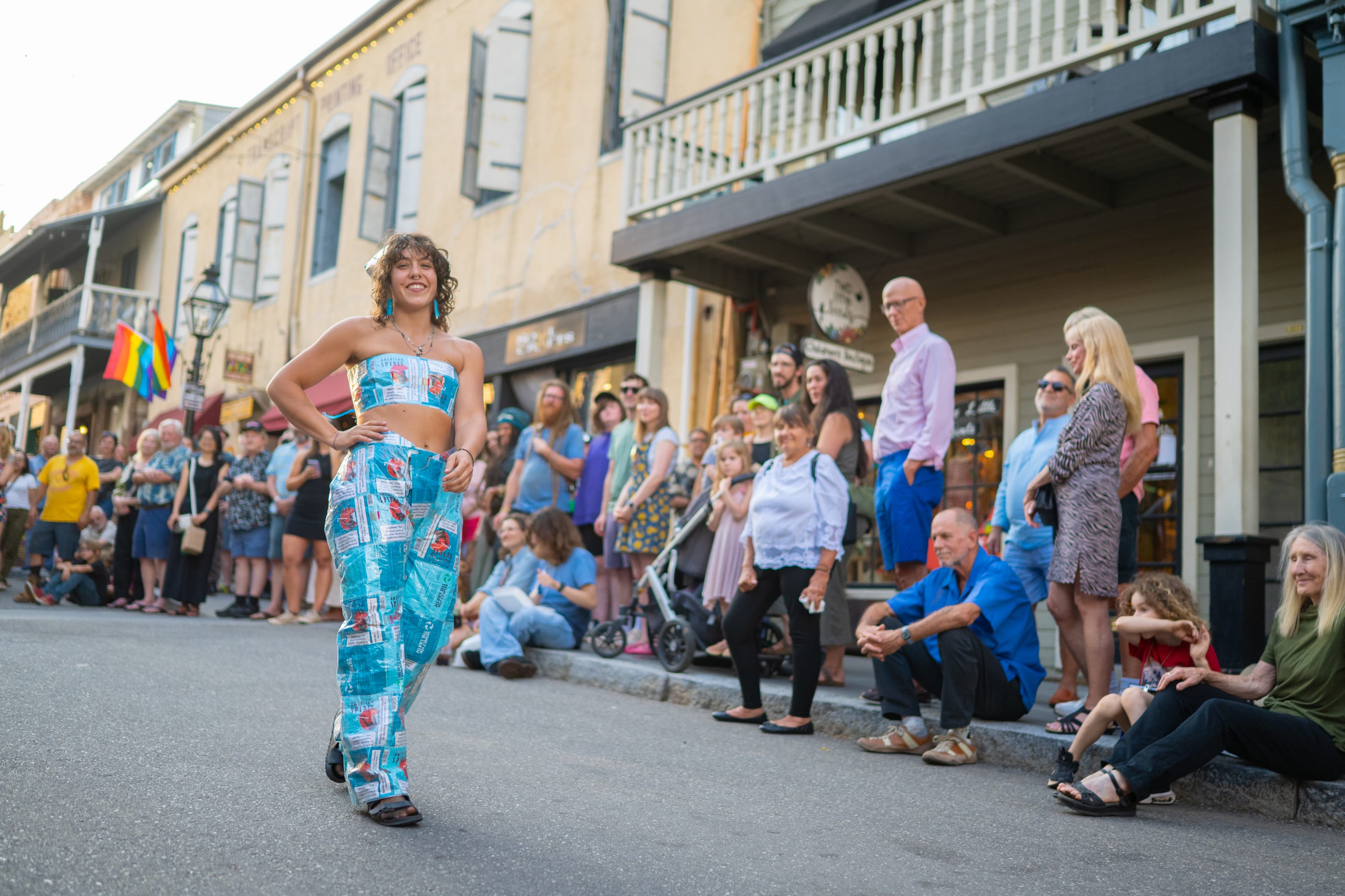 First Friday Art Walk- woman posing in a Haute Trash Couture Collection on street with crowd
