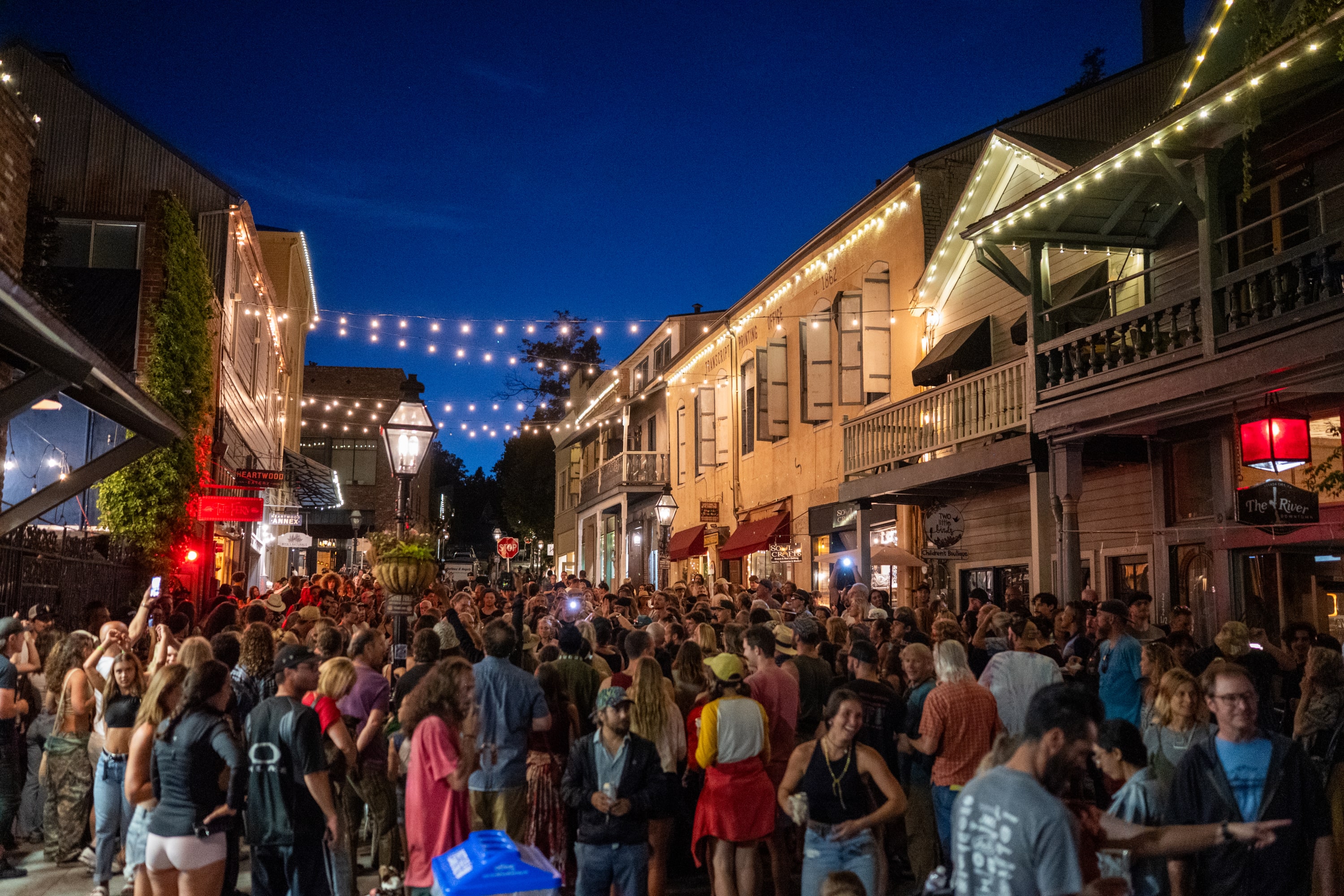 crowd filling Commercial St with string lights above at the Hot Summer Nights in Nevada City