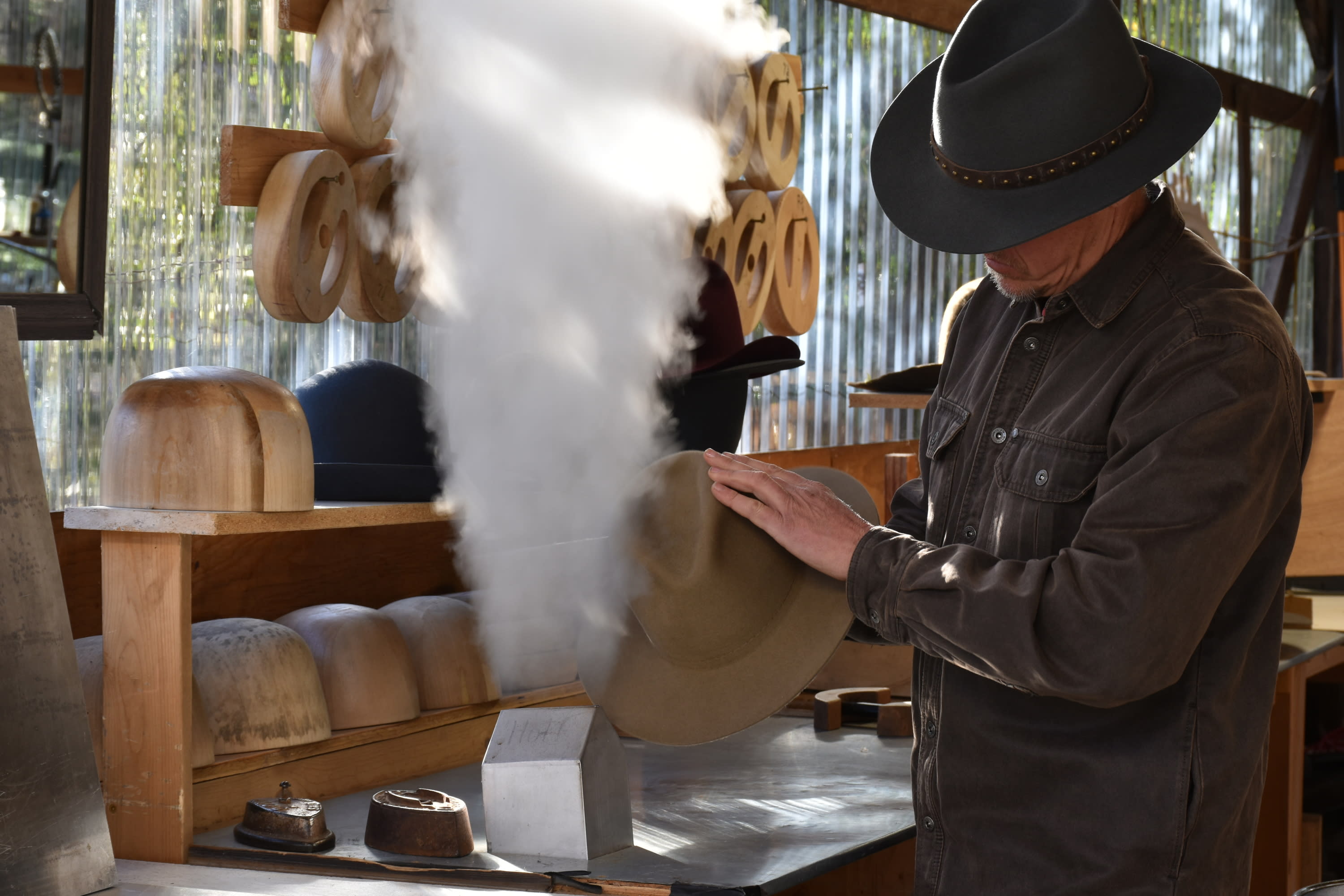Man steaming a hat