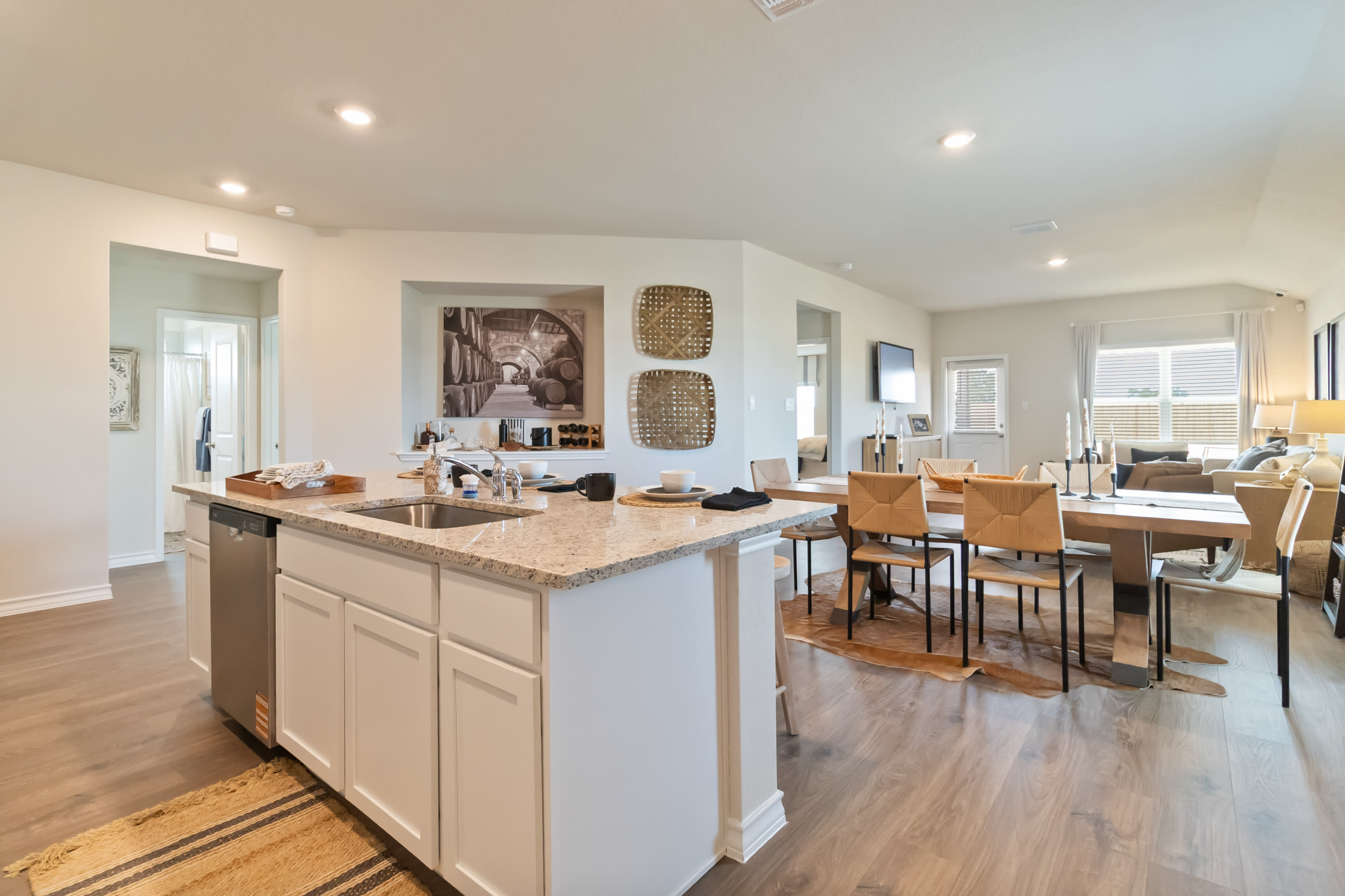 spacious kitchen island overlooking open concept dining area and living room
