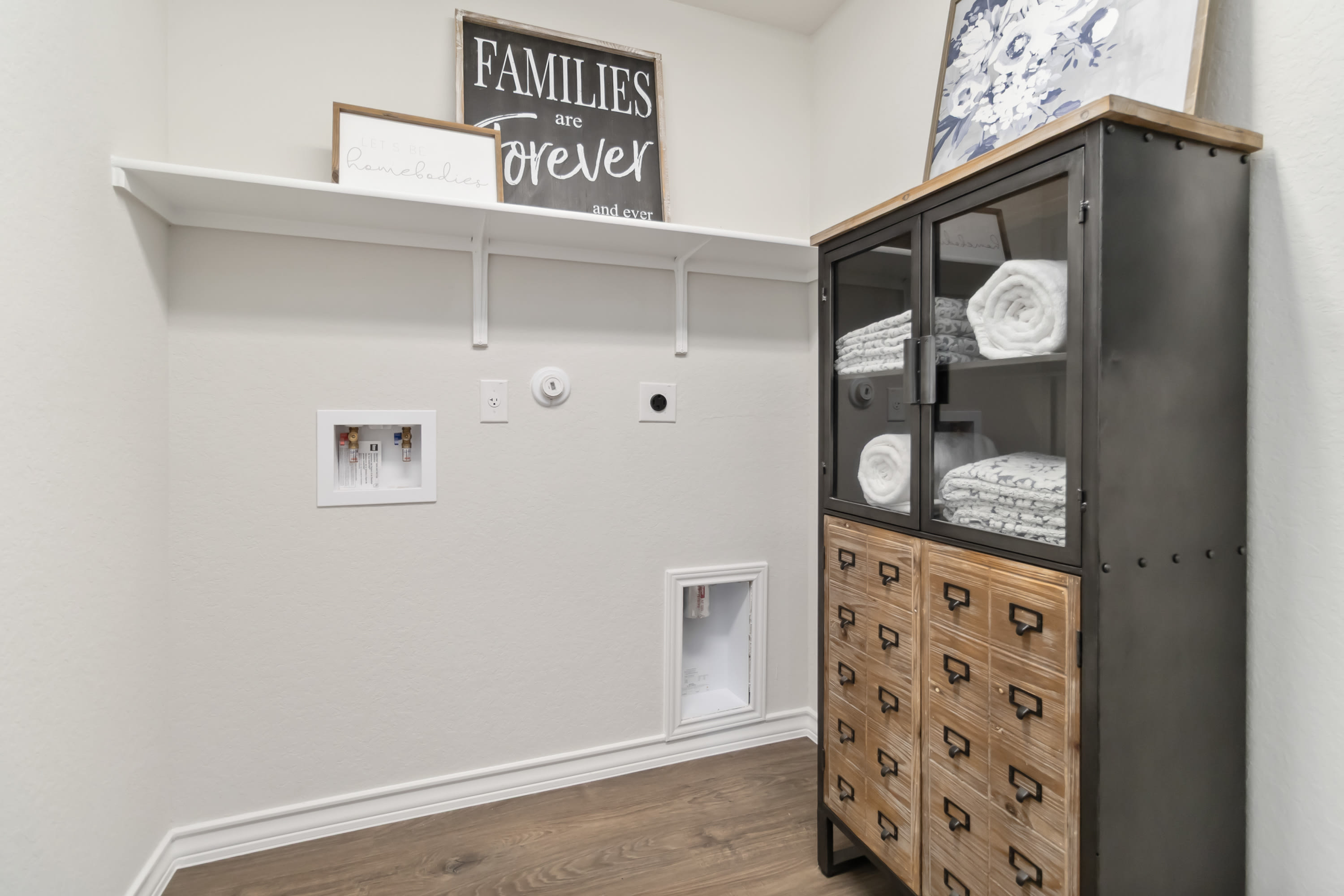 utility room with washer and dryer hook ups and built in shelves