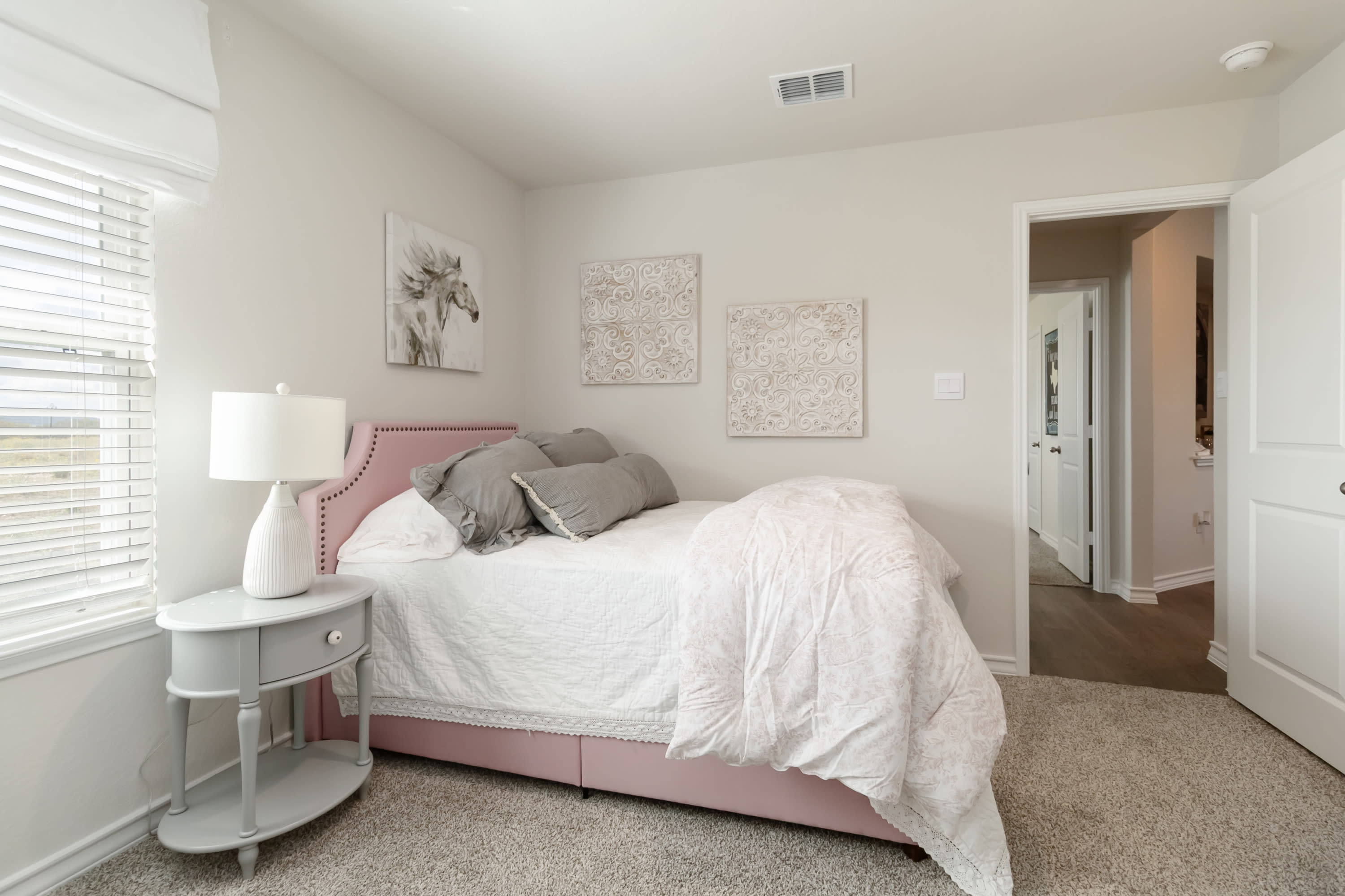secondary bedroom with carpet flooring and large window