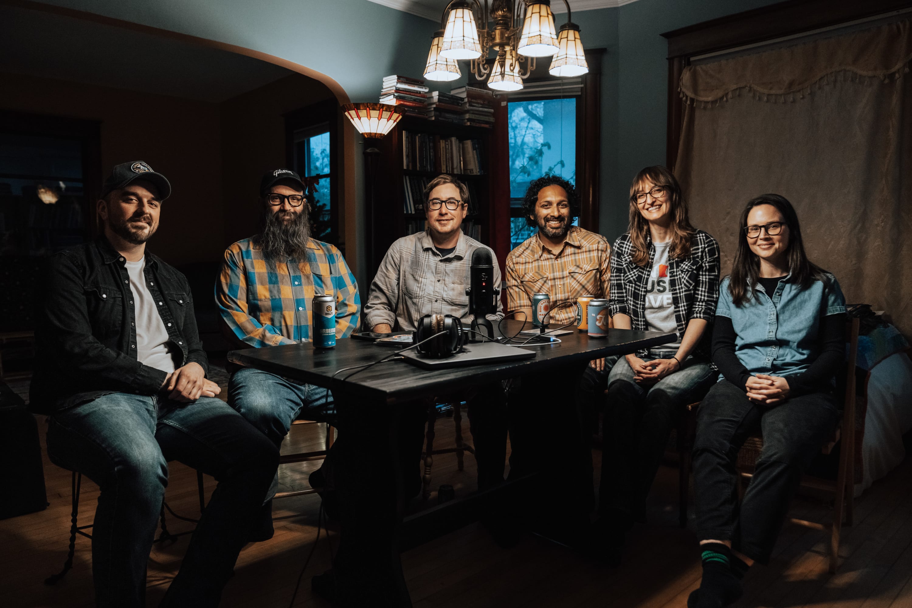 The Gated Community band sitting at a table.