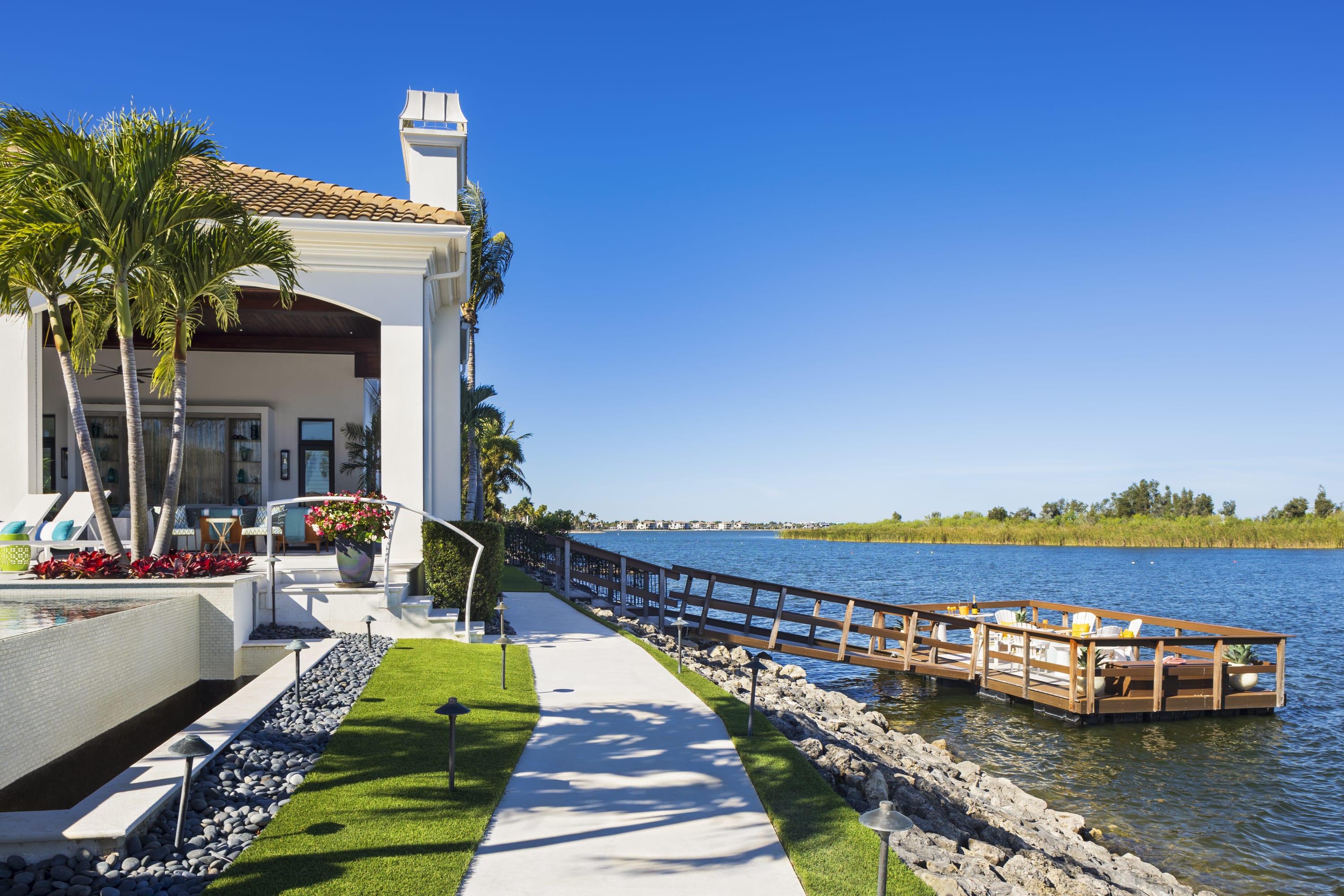 Custom outdoor living space and dock by Paterra Custom Homes