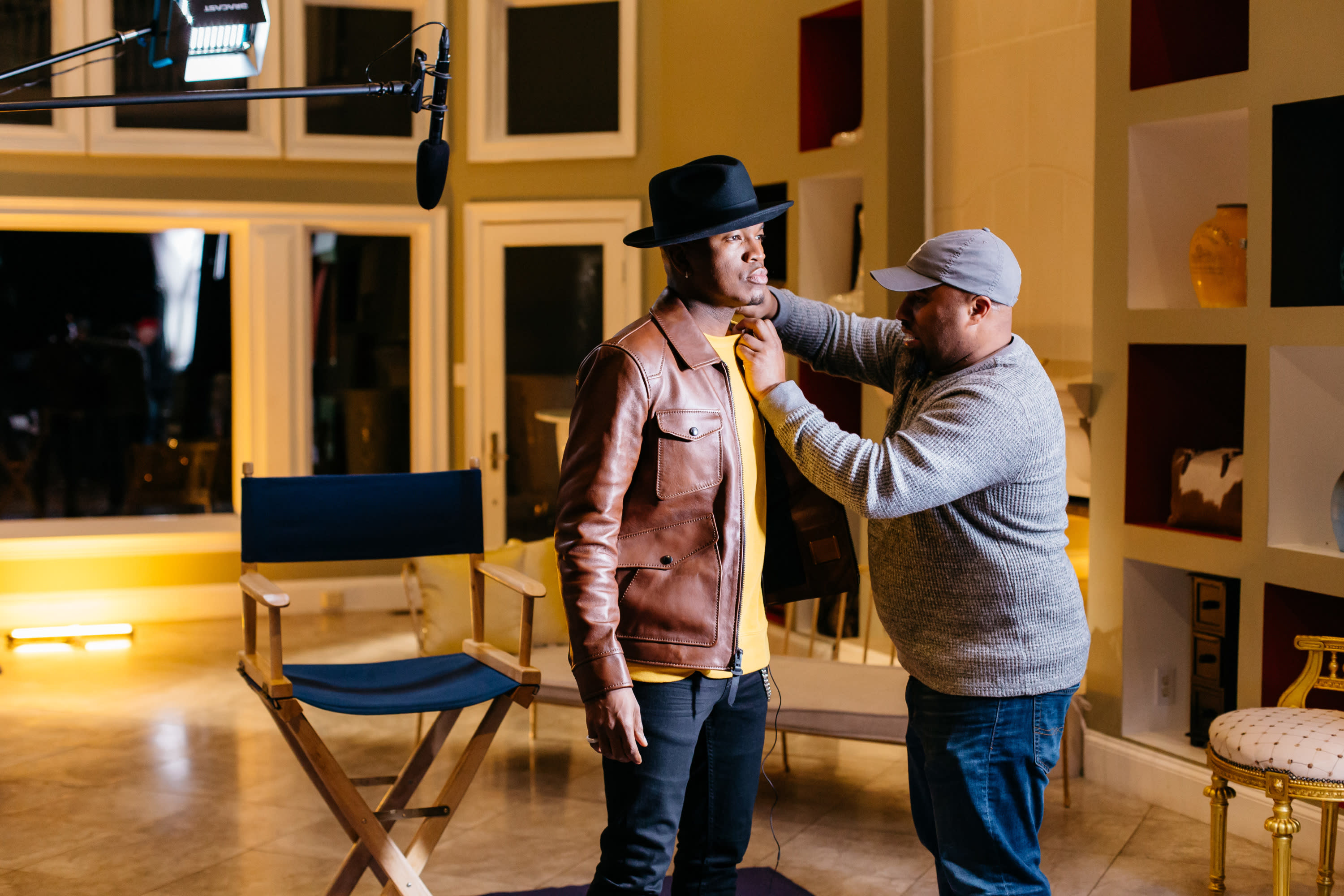 Sound operator putting a lapel mic on NEYO