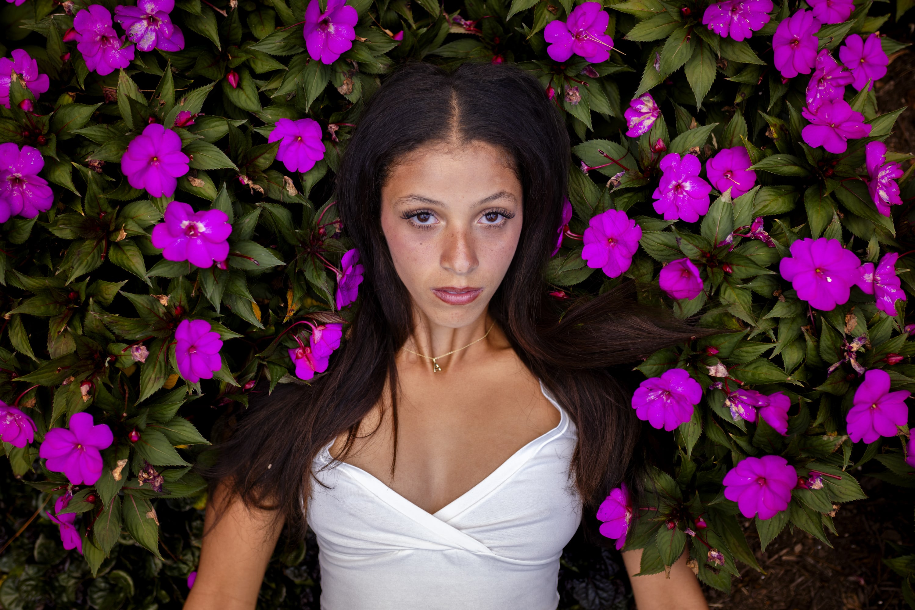 A high school senior laying in a field of flowers in Clinton