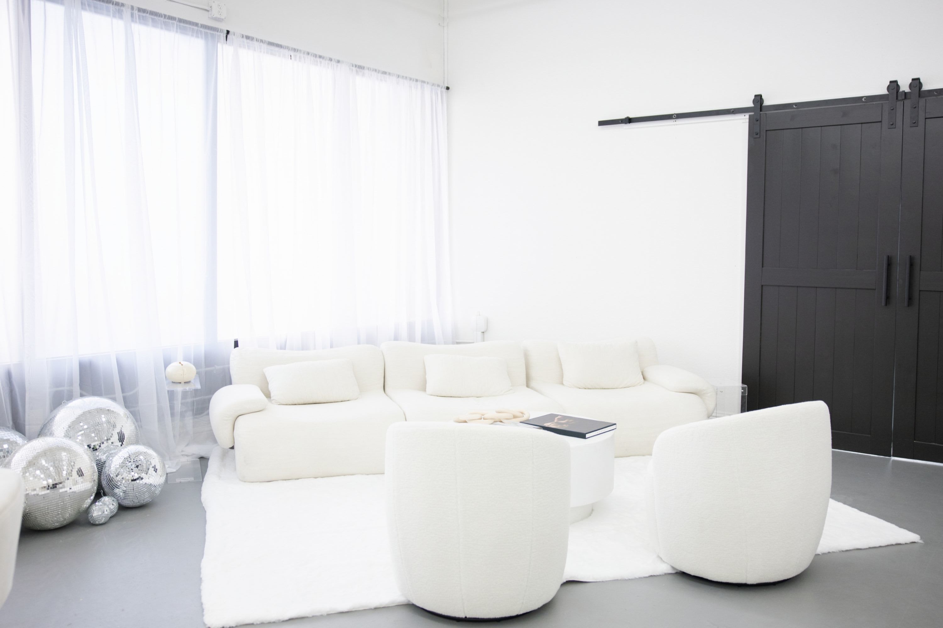Milou & Olin Photography studio lobby in Sacramento featuring modern white furnishings, natural light, and a luxury client ex