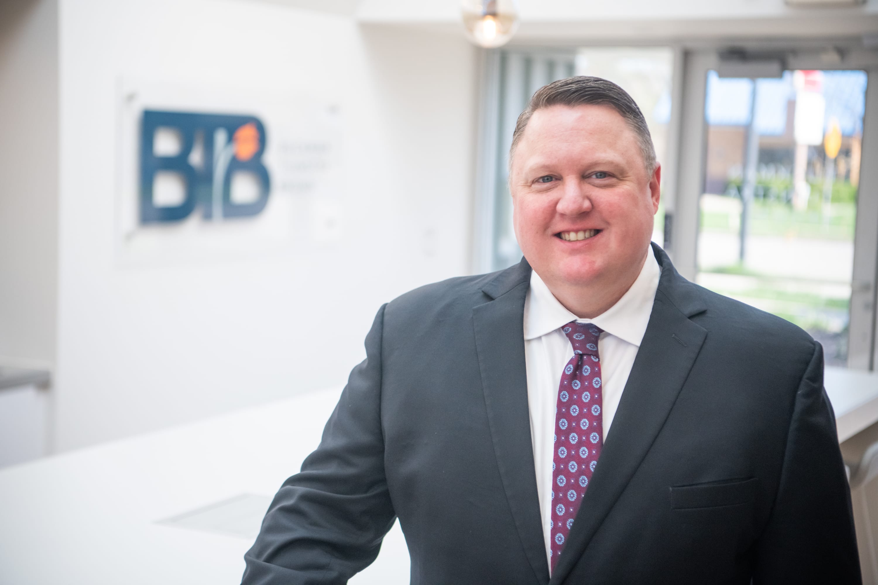portrait of a male attorney next to a BTB sign